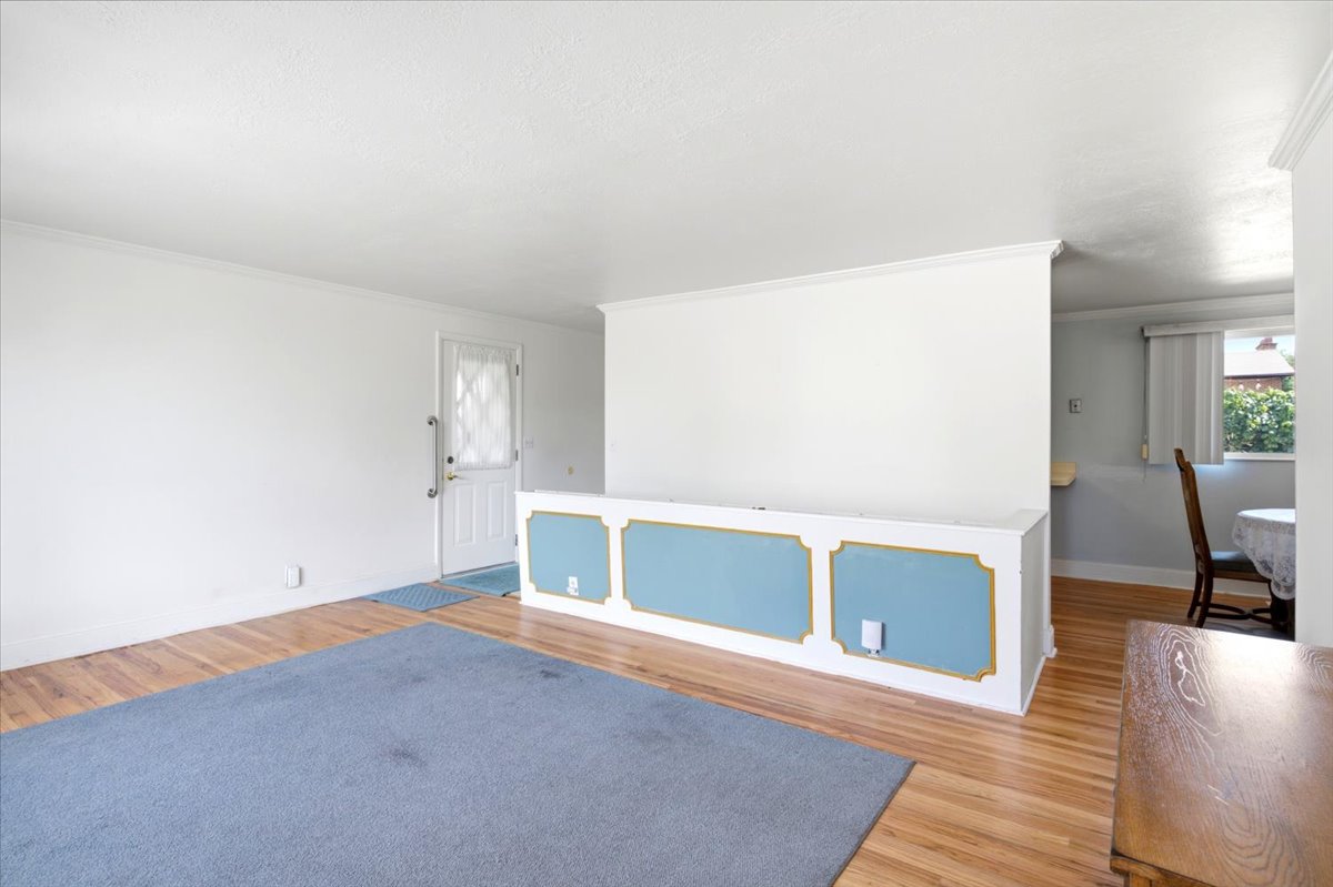 See the short wall with the blue rectangles? That is a privacy wall for the stairs going down to the basement. The back door is to the left of it.