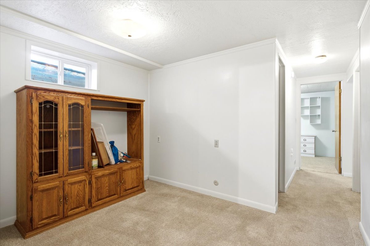 Little Den area at the bottom of the stairs to the left. The entry to the basement family room is to the right.