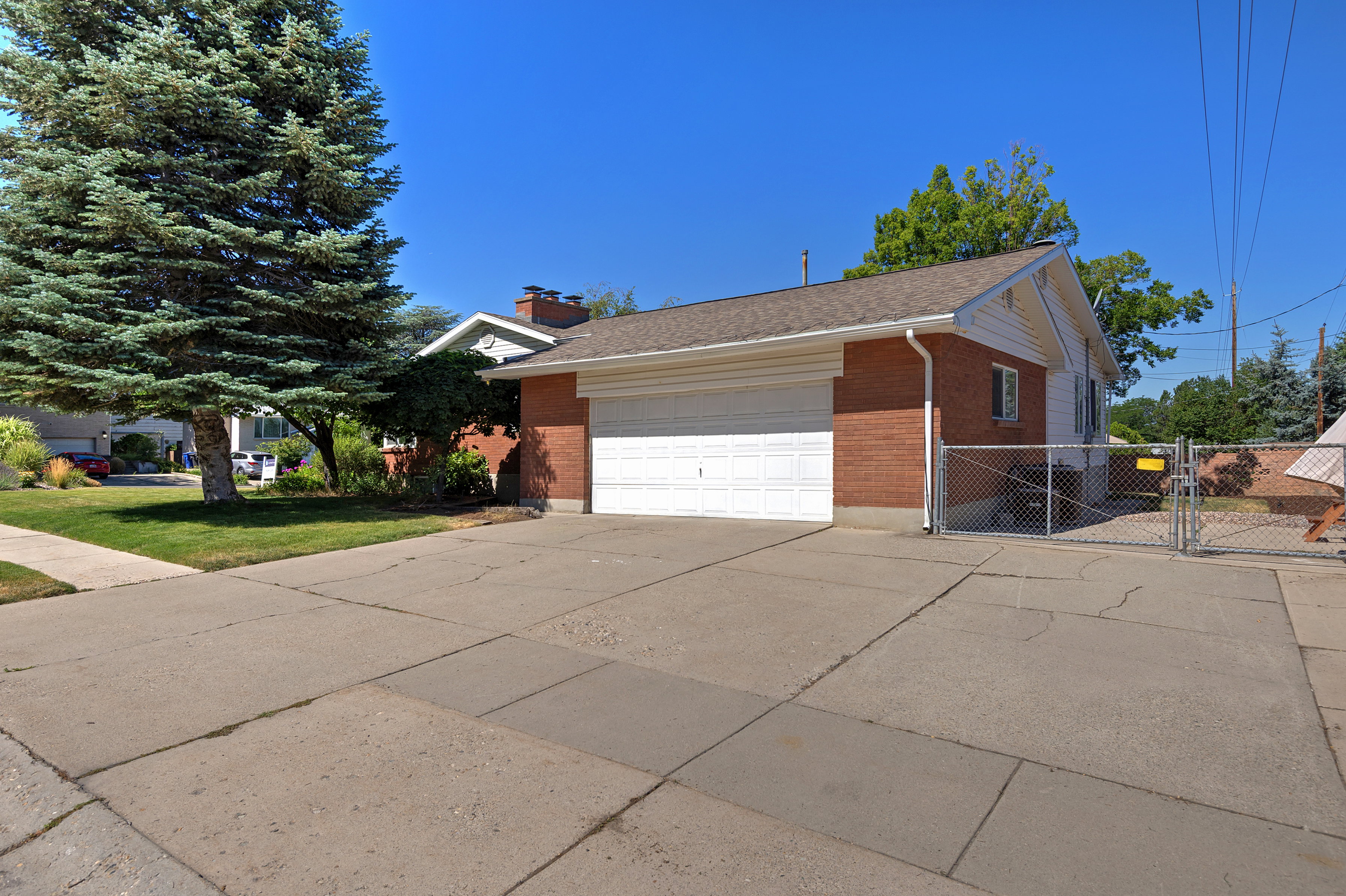 Brick-clad exterior with white garage door and matching siding