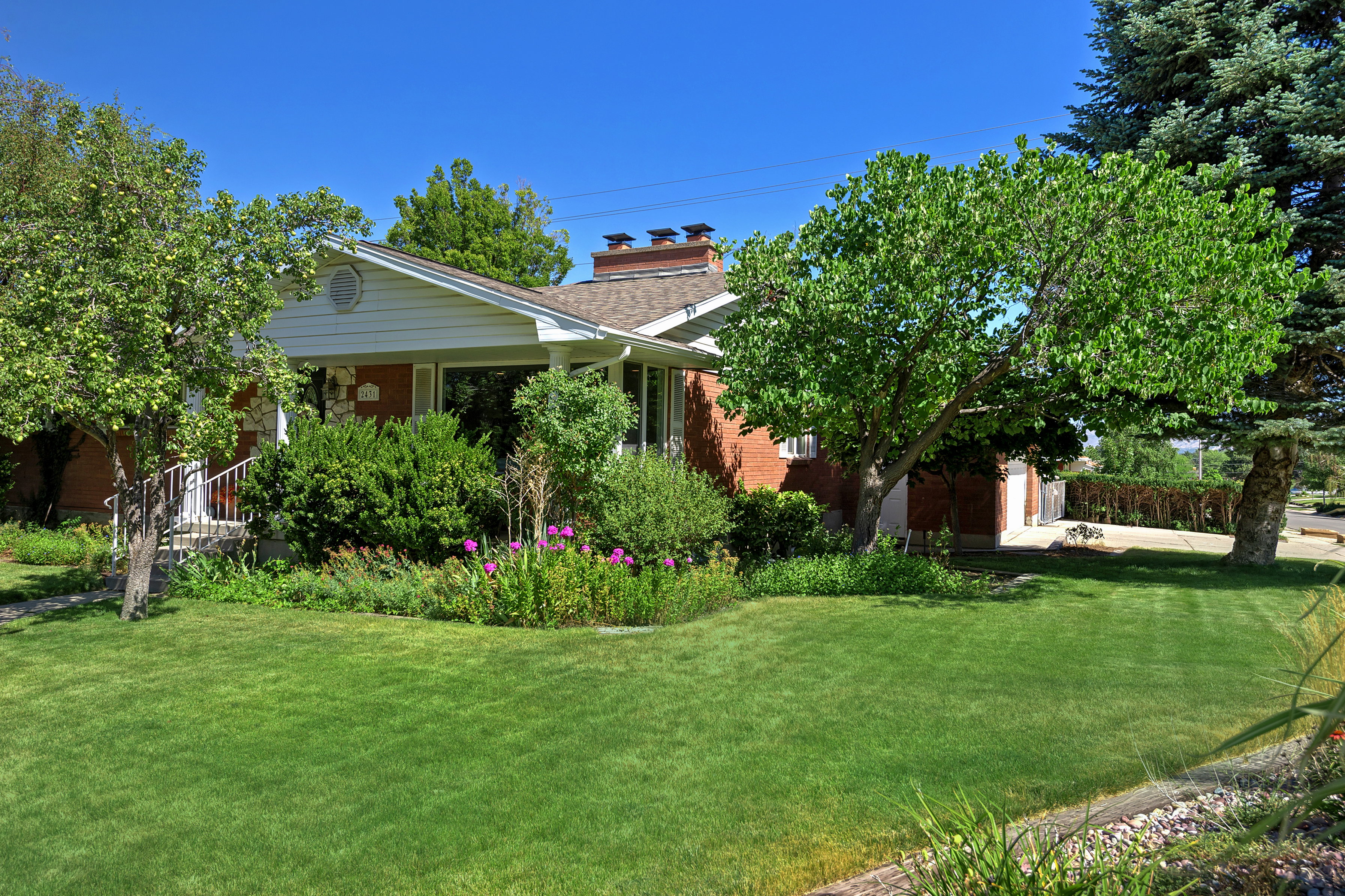 Traditional brick exterior with white siding accents and a gable roof