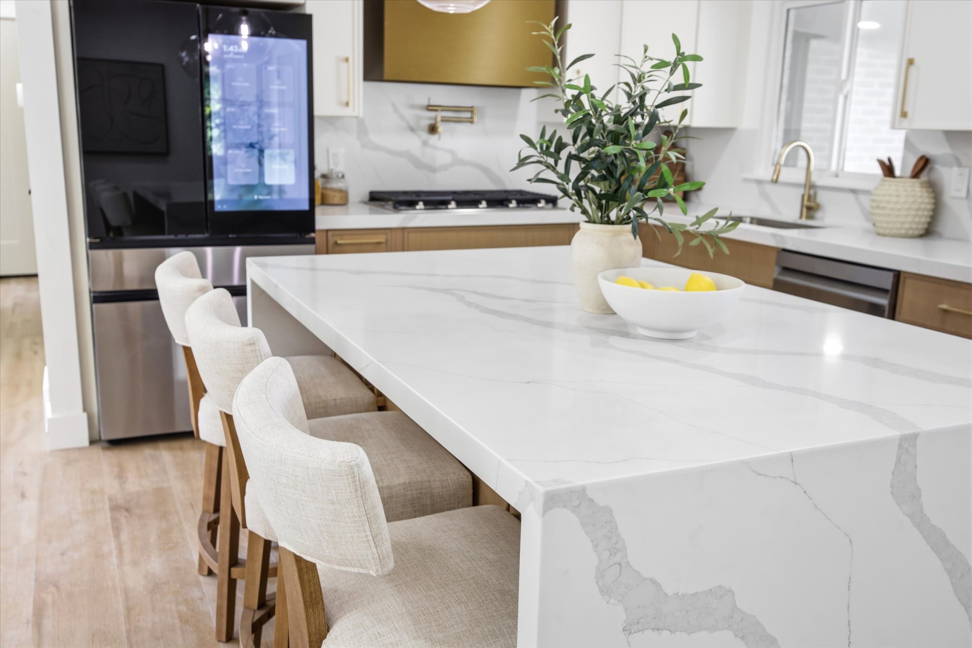 Waterfall kitchen island with a stone-finish countertop