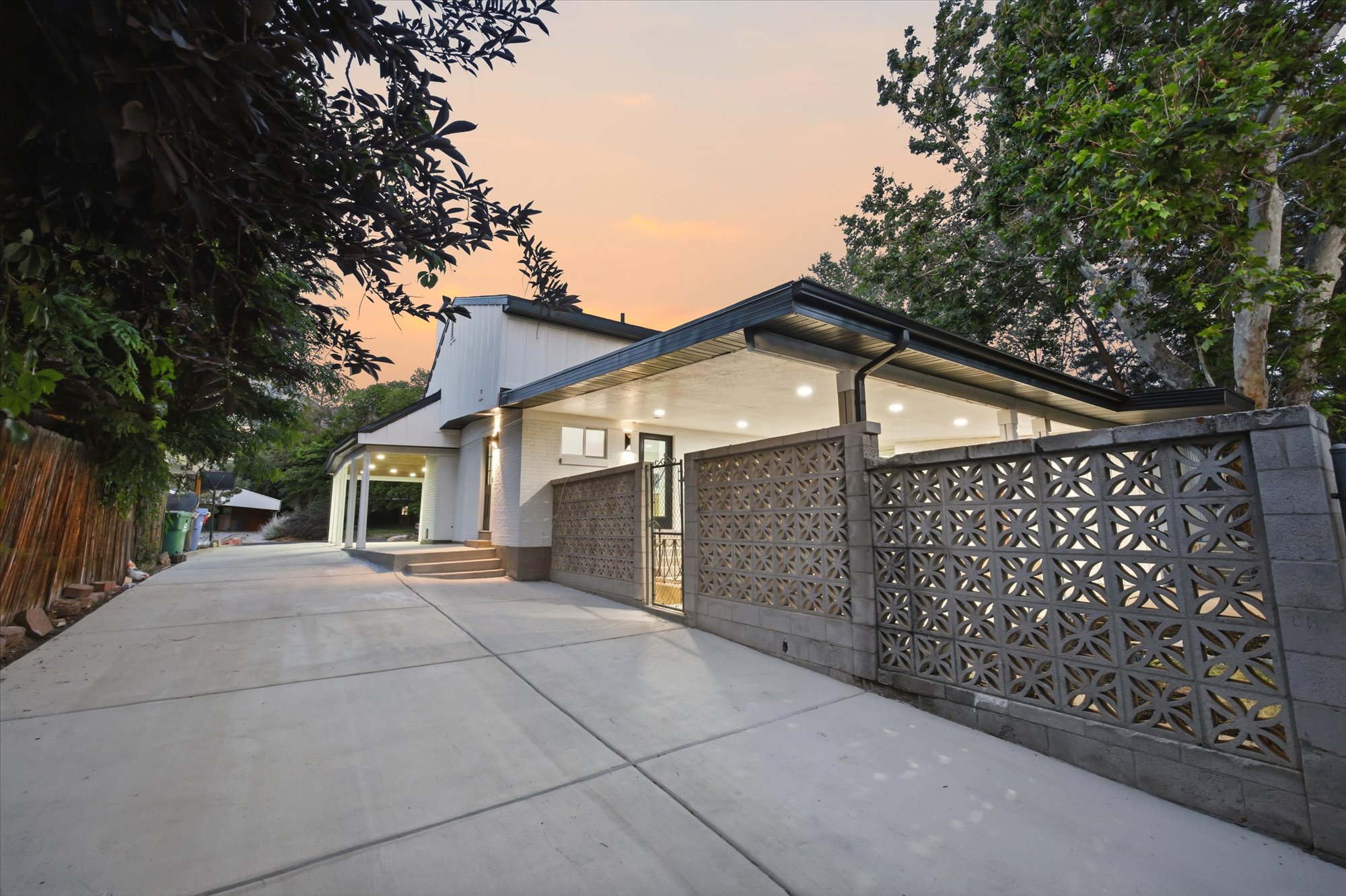 Expansive concrete driveway leading to a contemporary residence