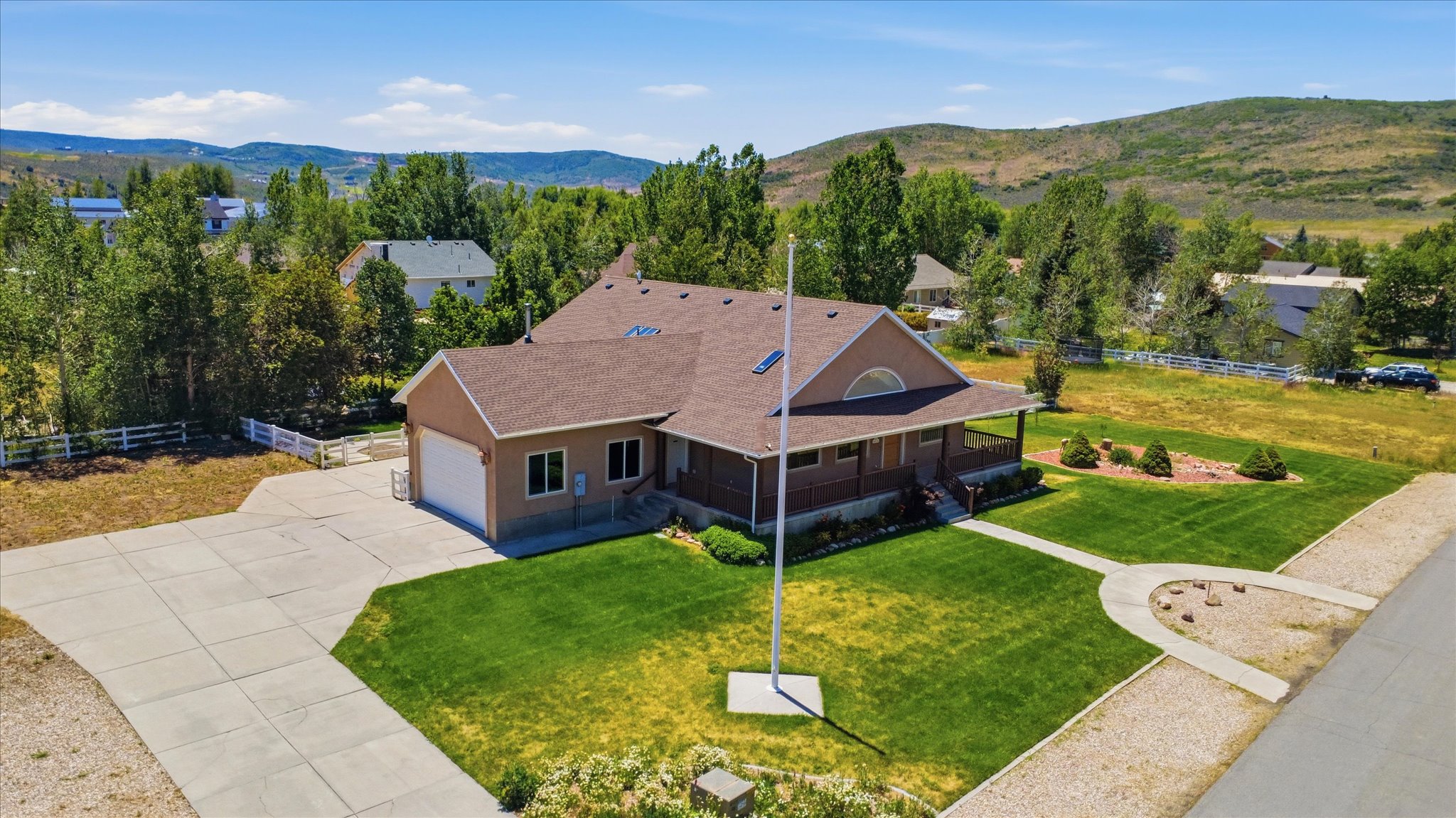 Craftsman-style residence featuring a prominent covered front porch and an attached two-car garage