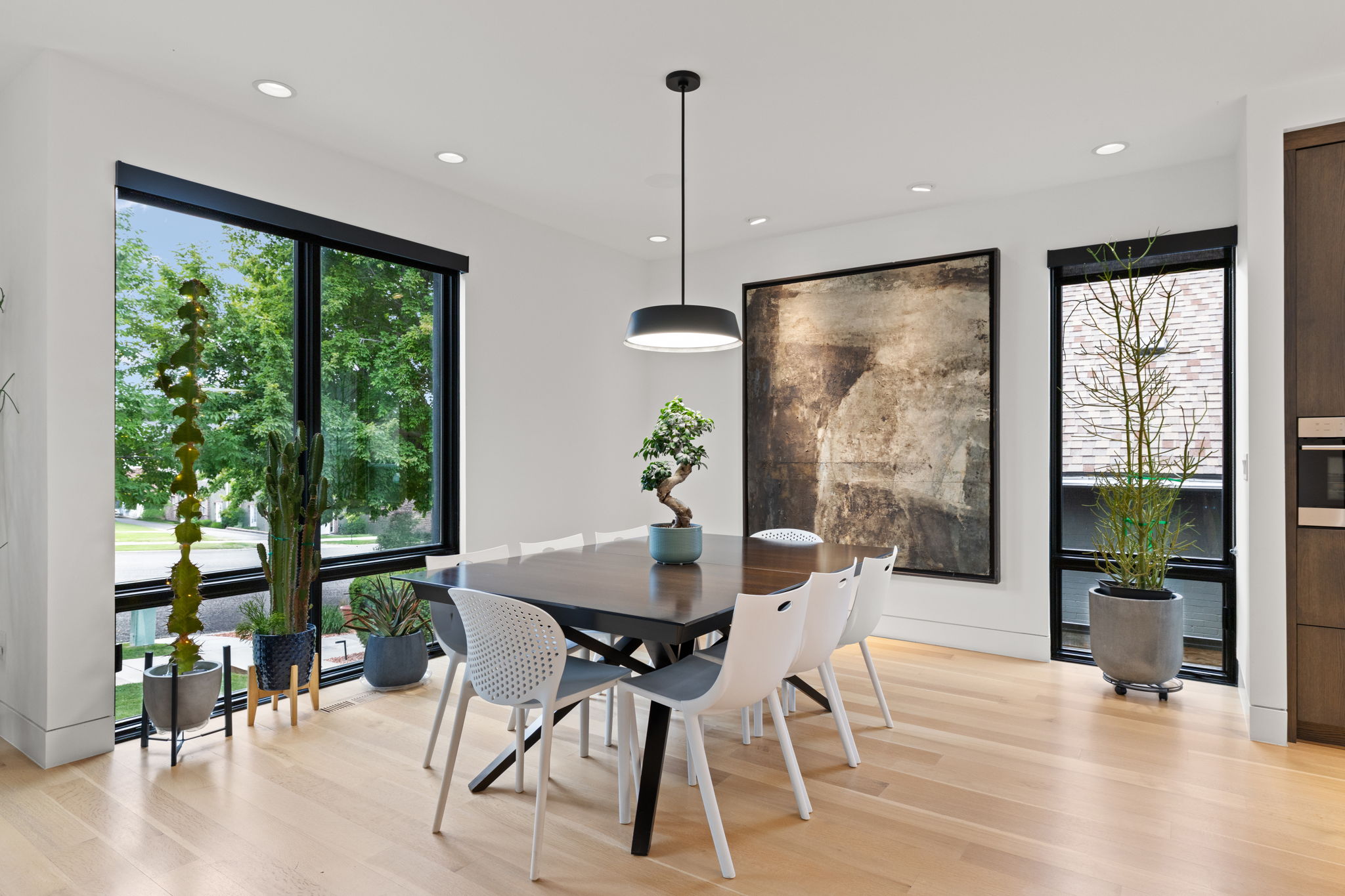 Dining area featuring light wood-finish flooring and recessed lighting