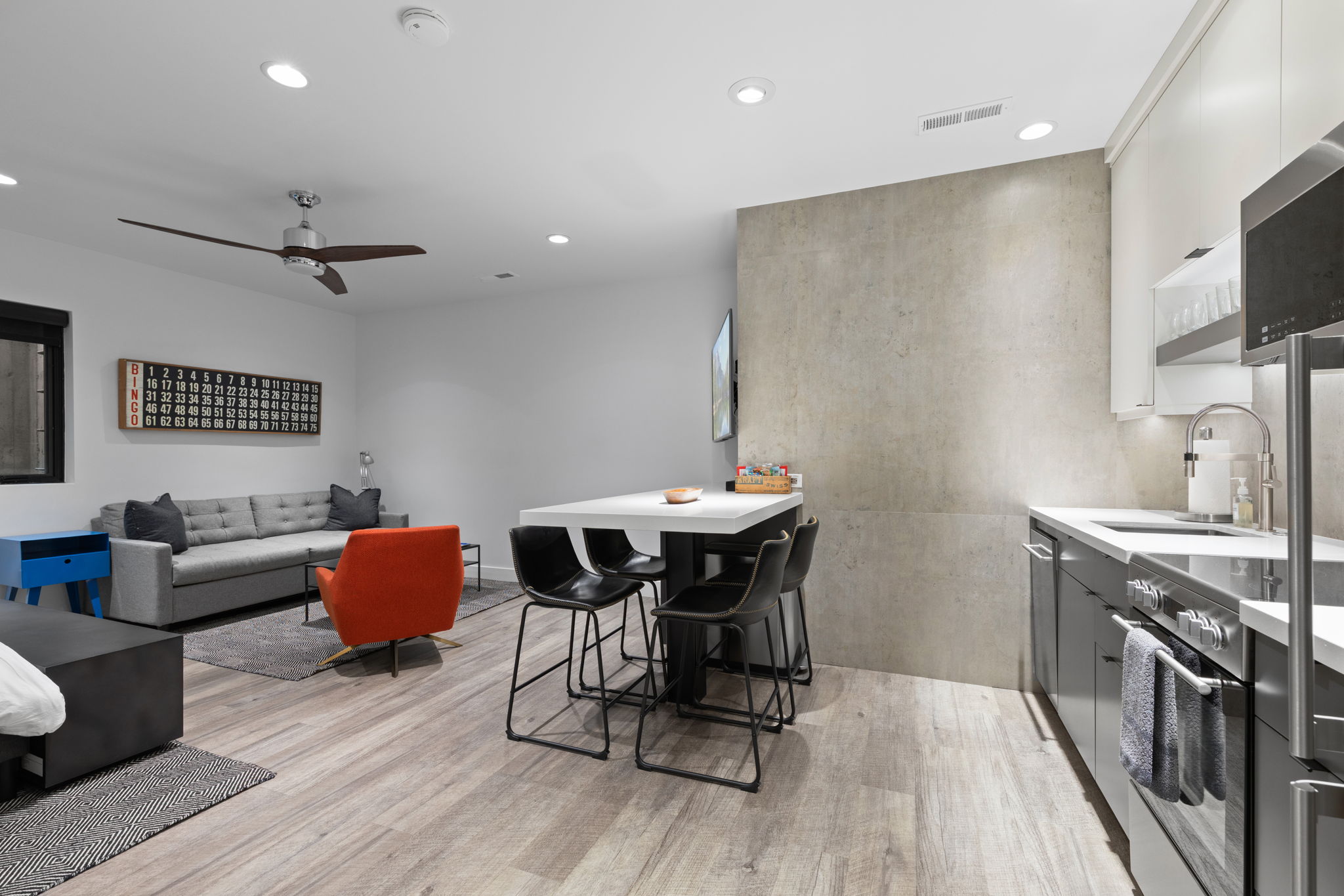 Open-concept living space featuring wood-finish flooring, recessed lighting, and a modern ceiling fan