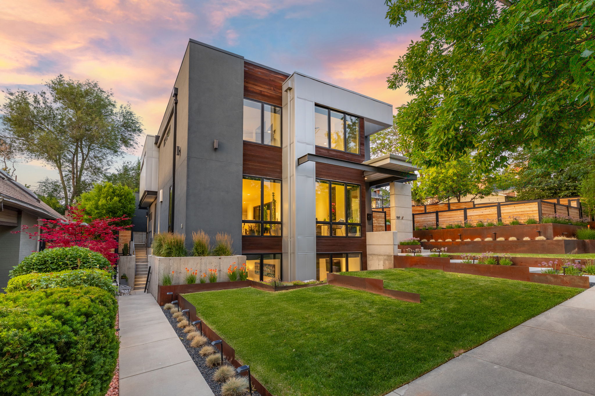 Modern architectural exterior featuring a stucco facade and wood-finish accents