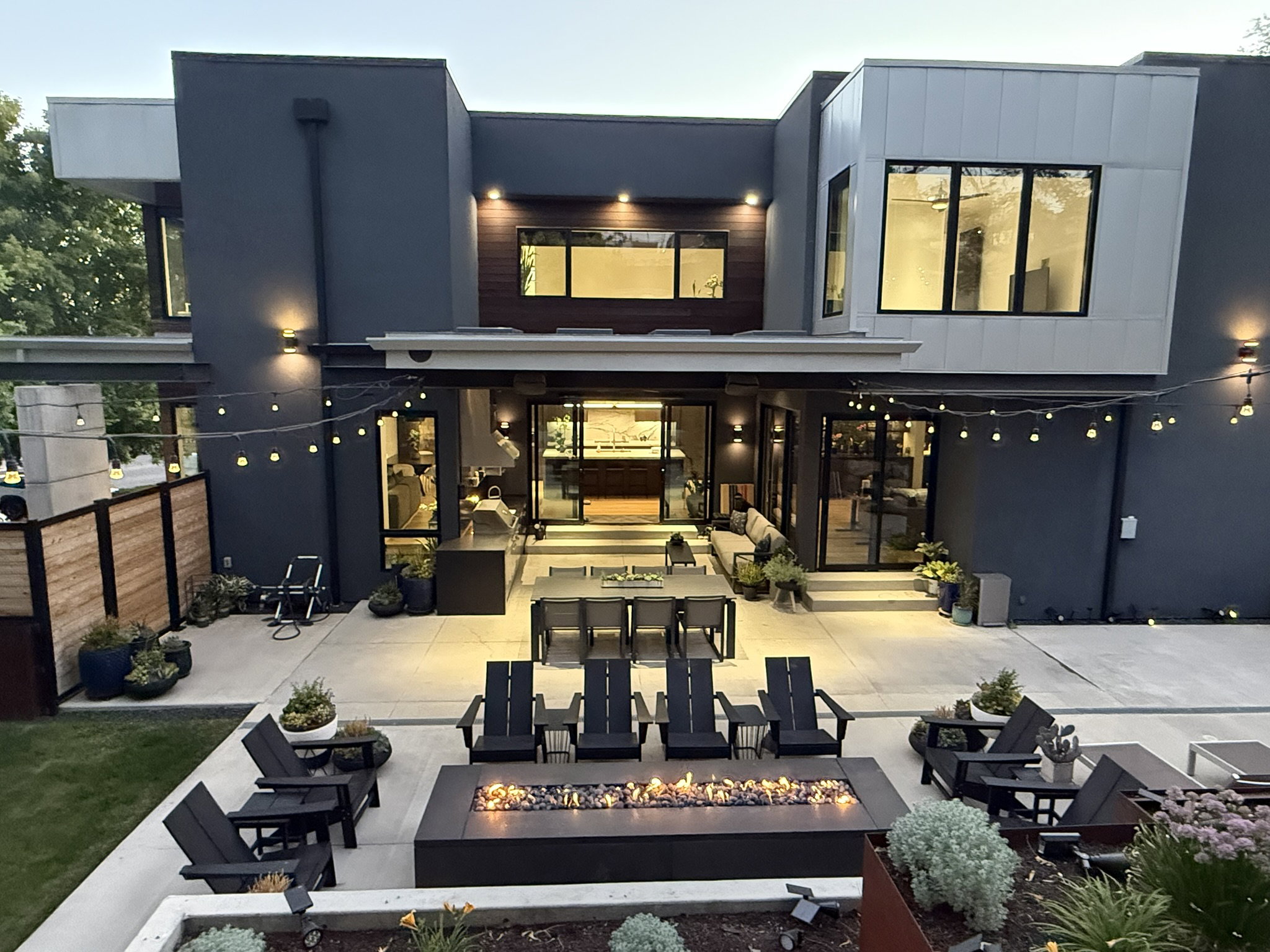 Modern exterior featuring dark gray and light gray siding with wood-finish accents