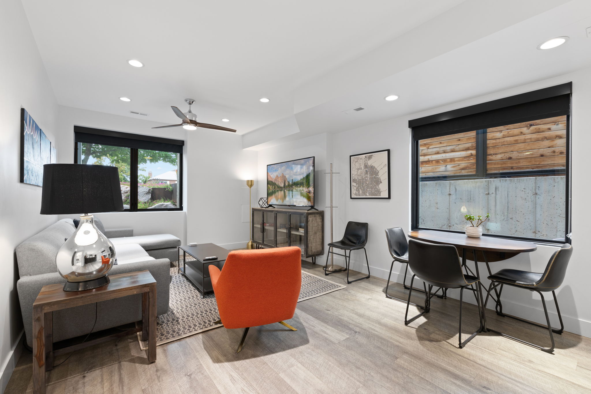 Open-concept living space featuring wood-finish flooring, recessed lighting, and a ceiling fan