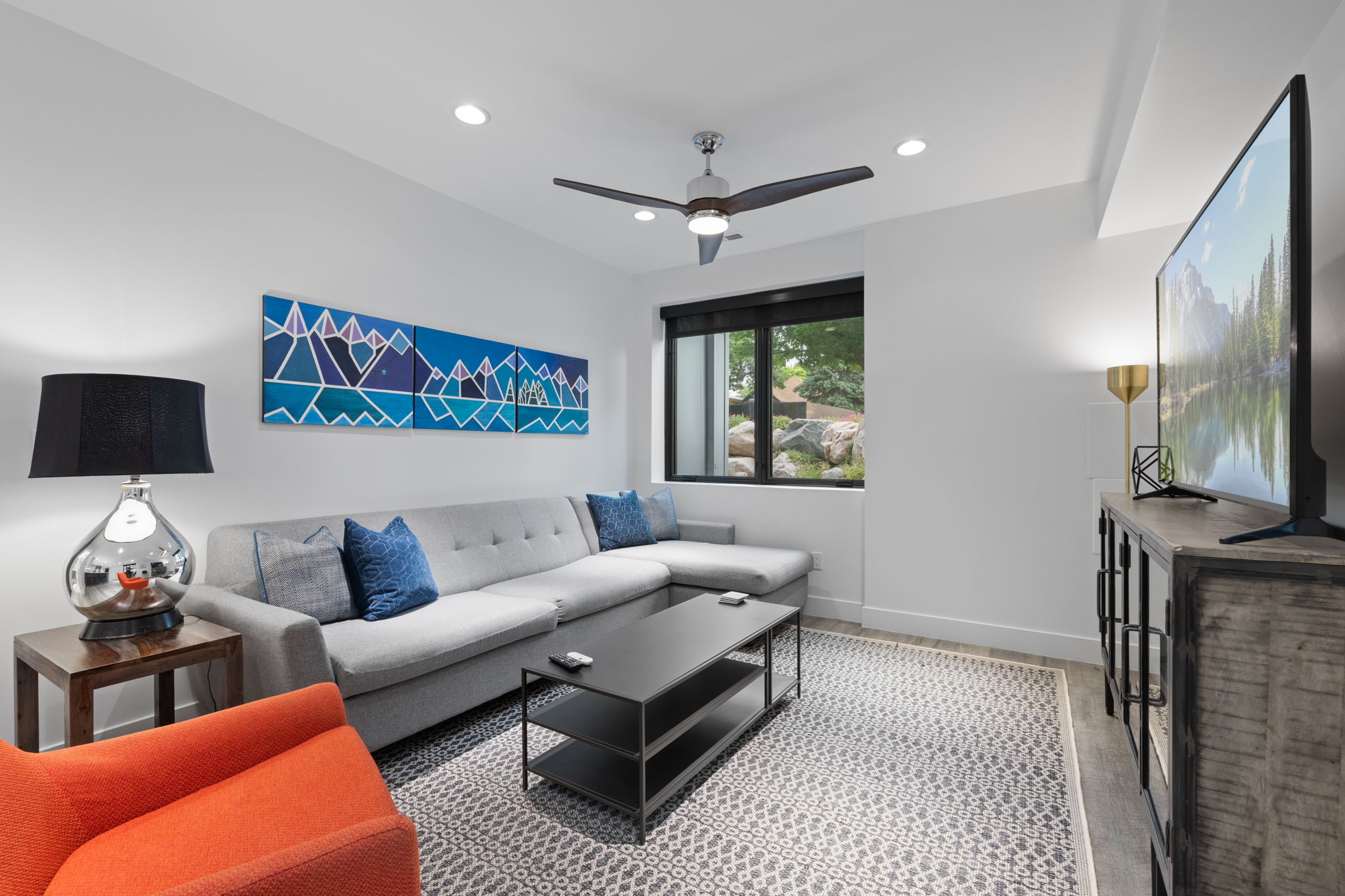 Living area featuring recessed lighting, a modern ceiling fan, and a large window