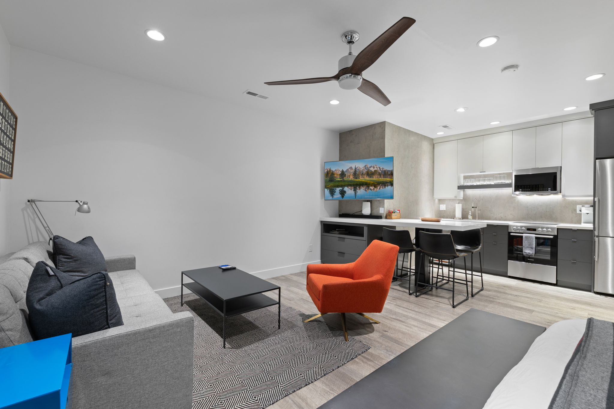 Open-concept living space with recessed lighting and a ceiling fan