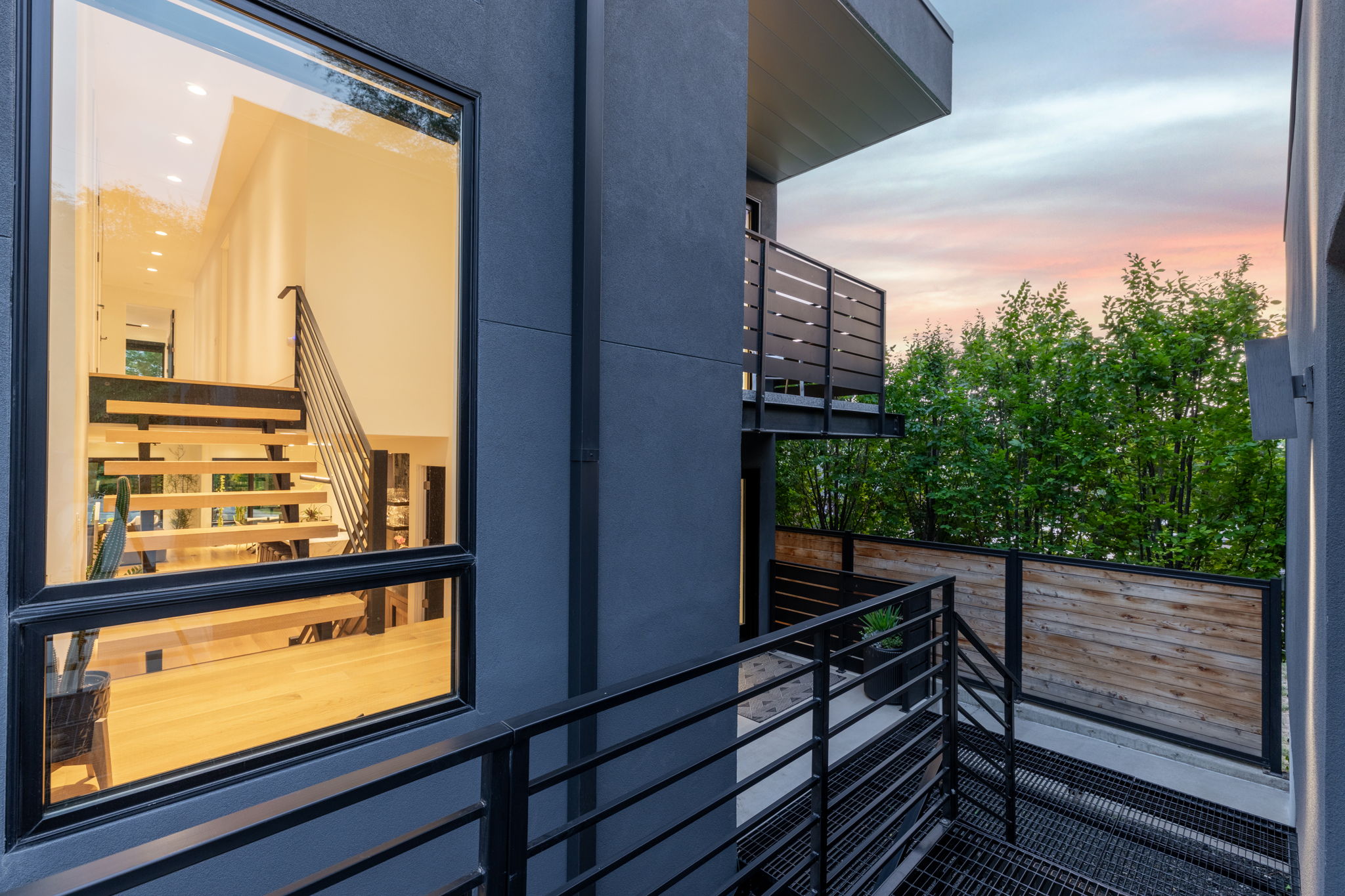 Modern exterior featuring dark gray siding and black-framed windows