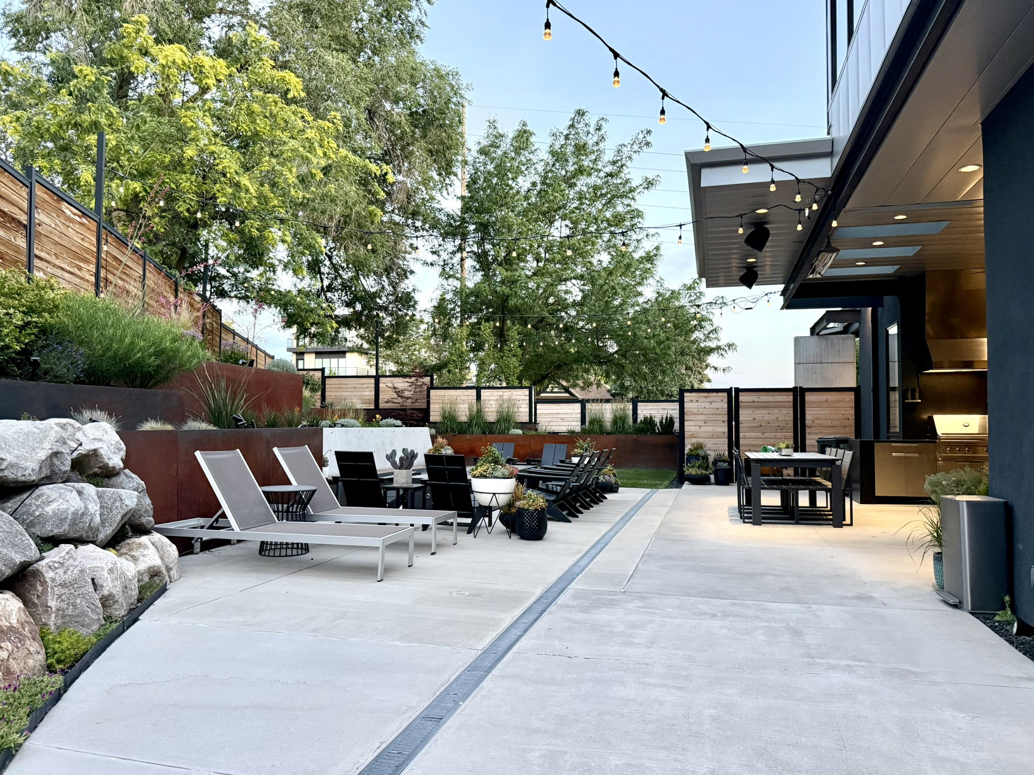 Expansive concrete patio area featuring integrated drainage