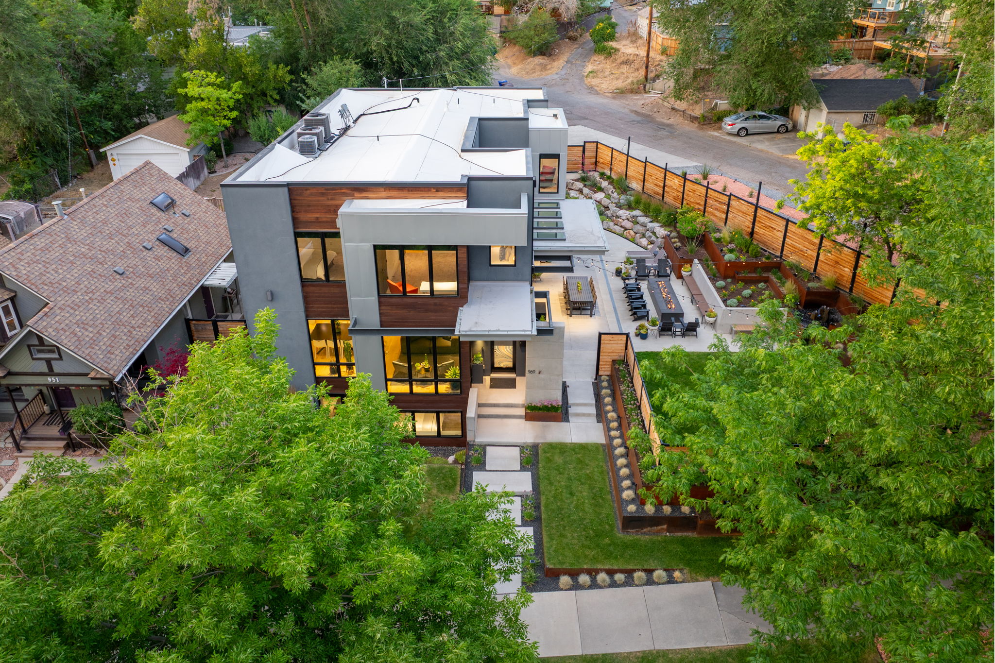 Modern multi-level residence featuring a flat roofline and exterior cladding in wood-finish panels and grey tones
