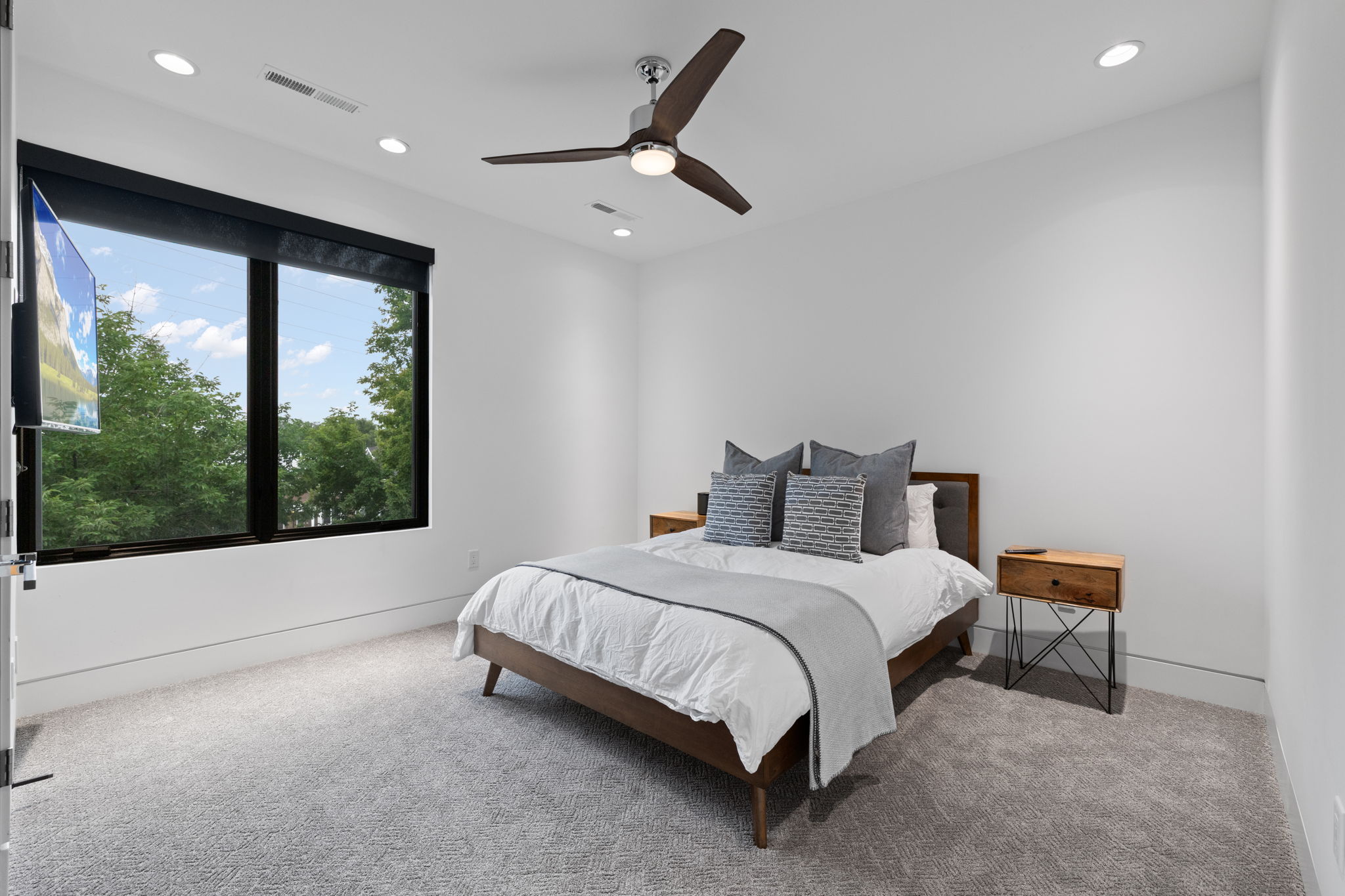 Bedroom featuring a large window, recessed lighting, and a ceiling fan