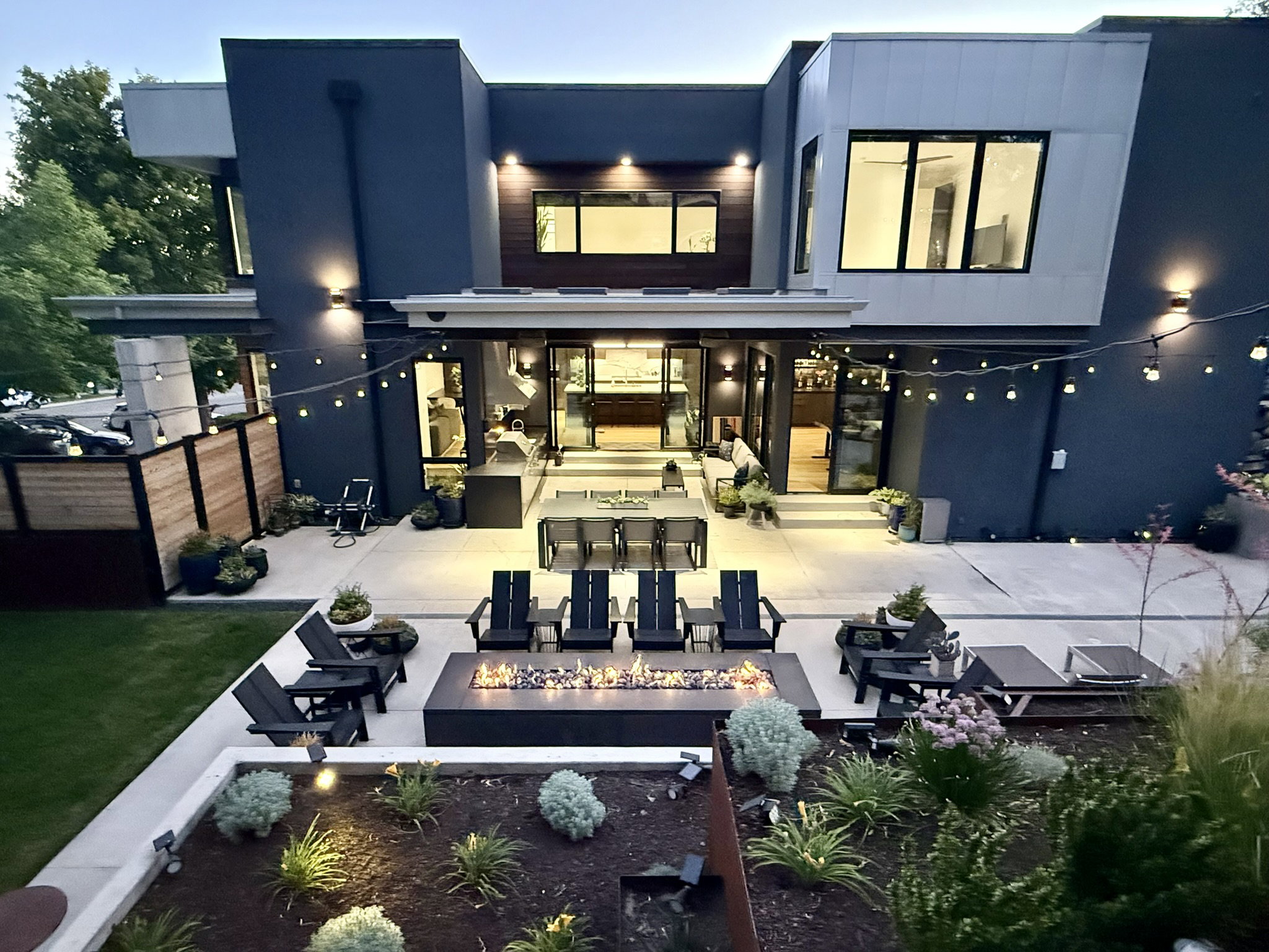 Modern exterior featuring dark gray and light gray paneling with wood-finish accents