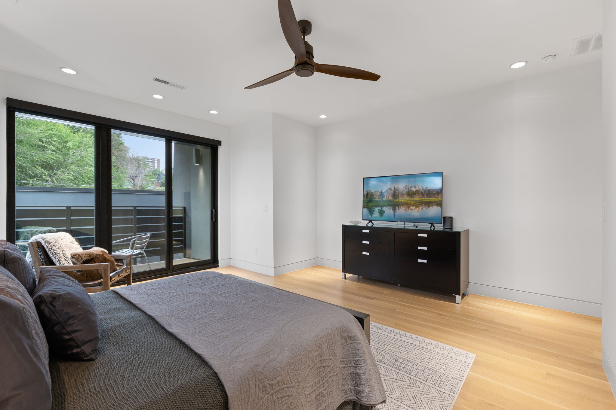 Bedroom featuring light wood-finish flooring, recessed lighting, and a modern ceiling fan