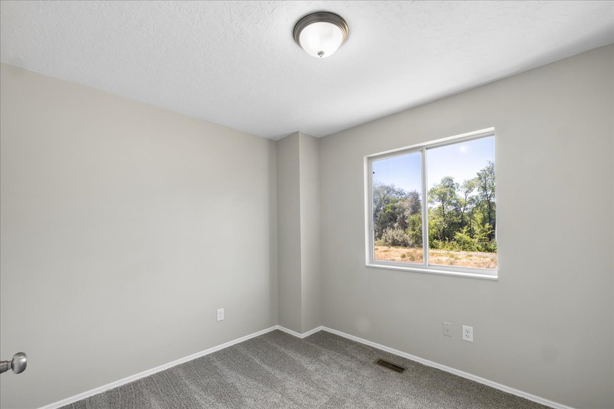 Neutral-toned walls complement plush carpeting