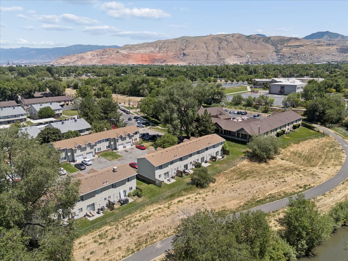 Aerial perspective showcasing multiple two-story residential buildings with tan roofs and light-colored siding