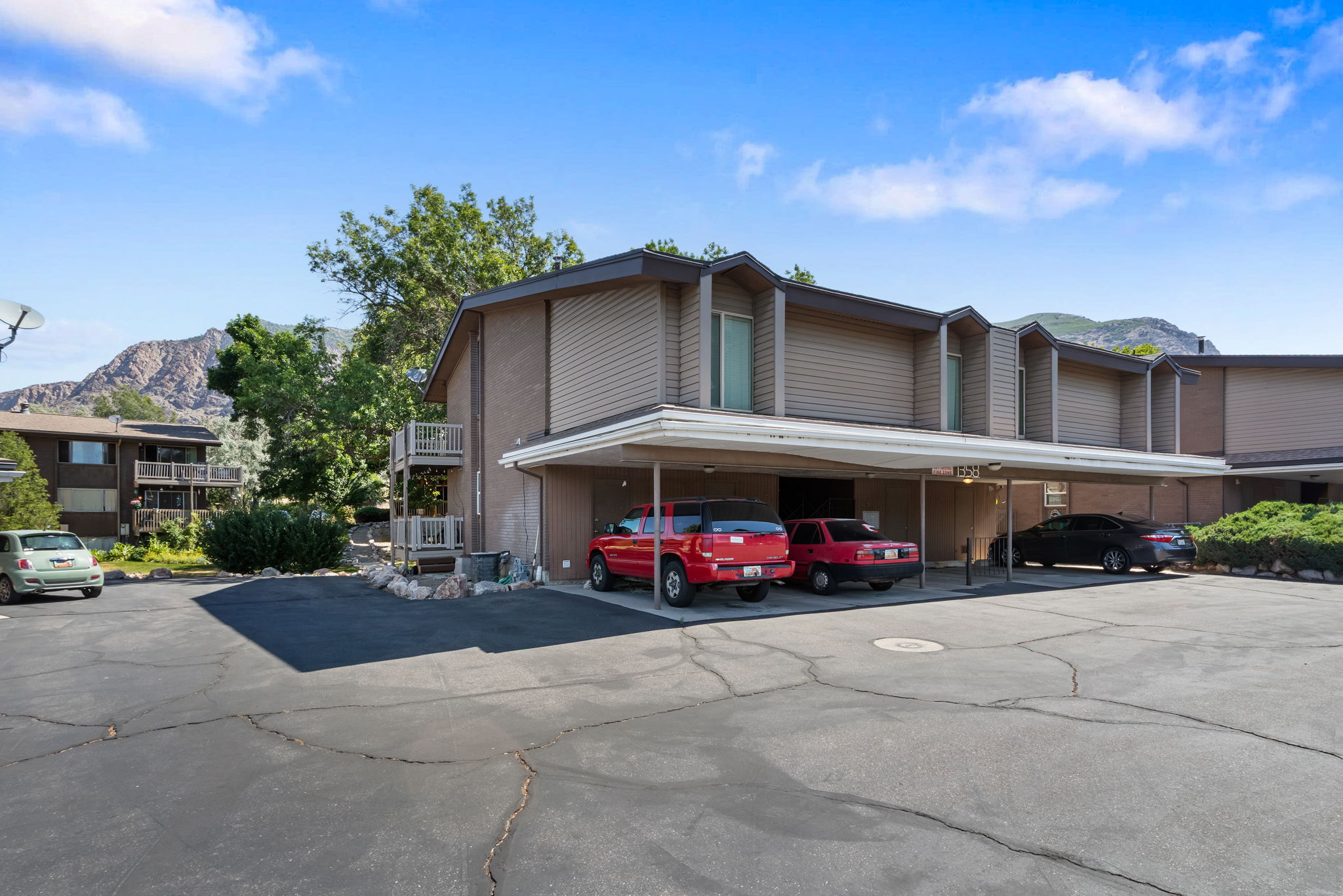 Multi-unit building featuring a stucco and horizontal siding exterior with a flat roofline