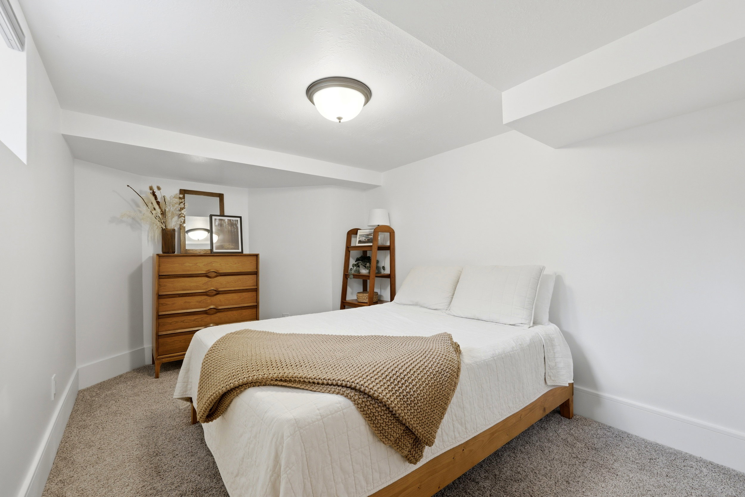 Carpeted room with white walls, baseboards, and ceiling