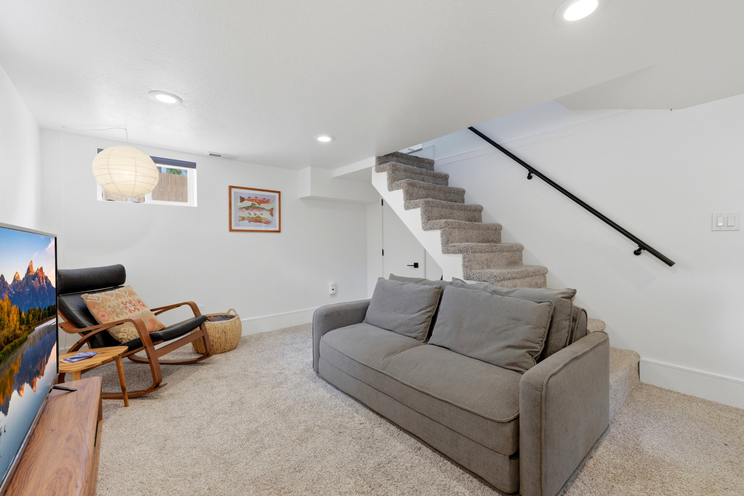 Carpeted recreation area featuring white walls and recessed lighting