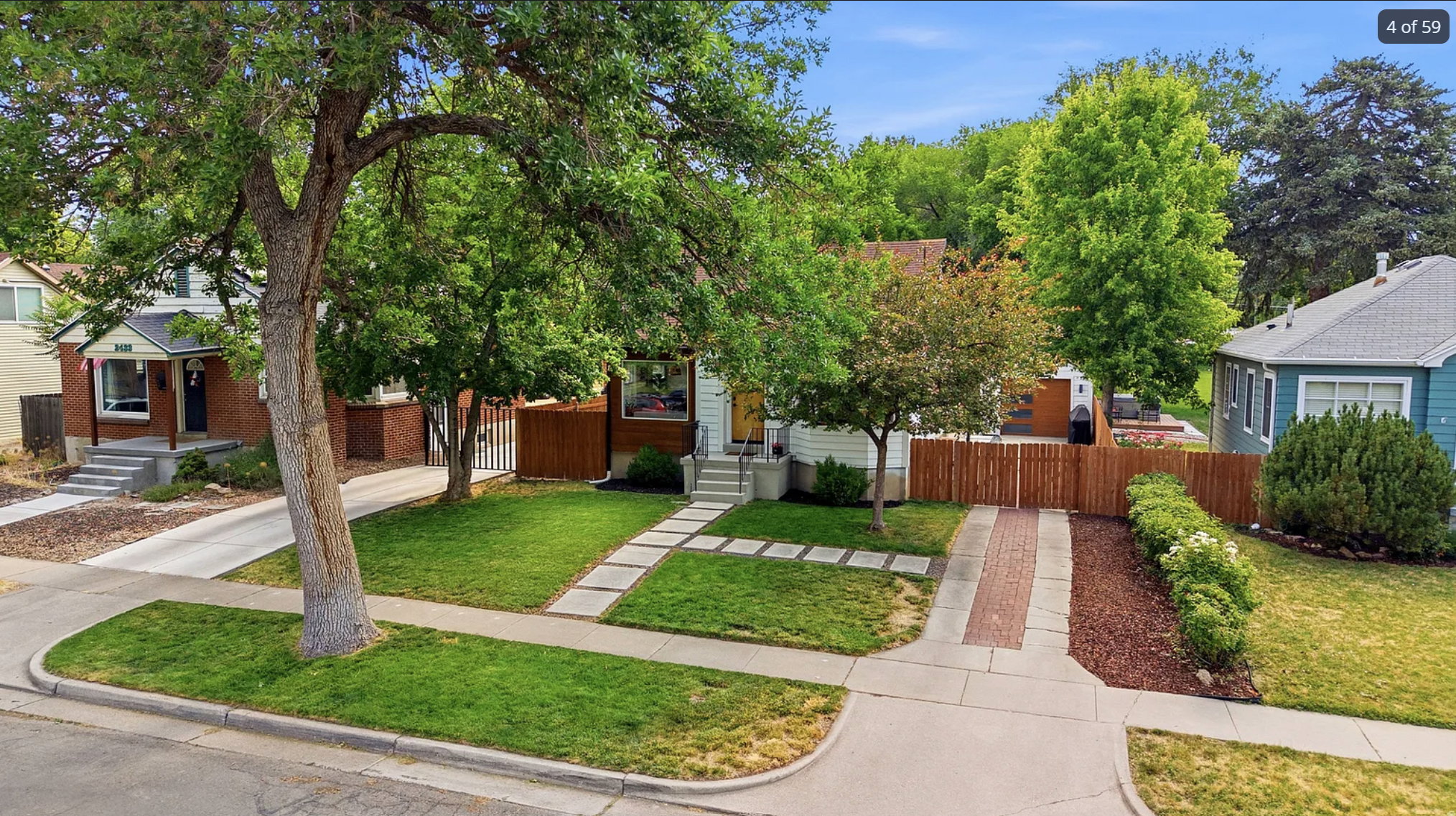 Manicured front yard with mature trees