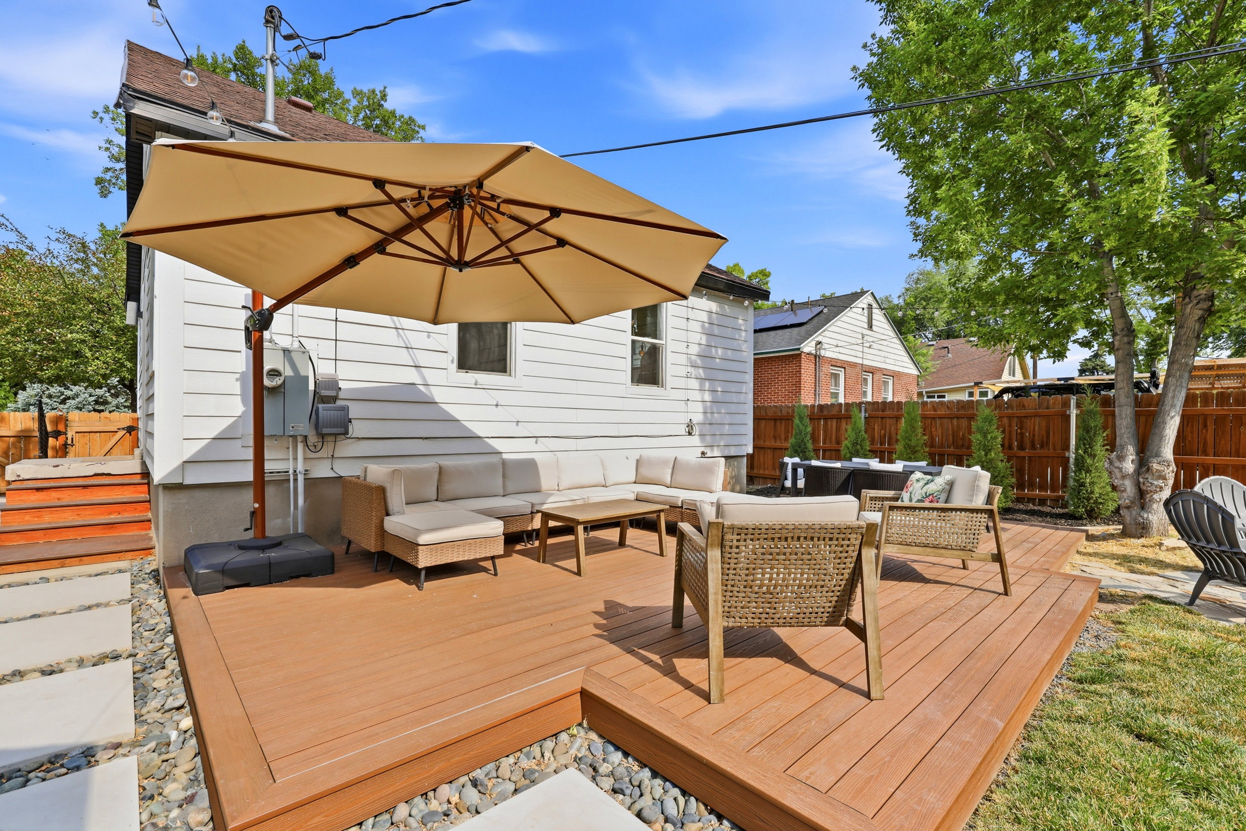 Spacious backyard featuring a multi-level deck, white siding, and a privacy fence