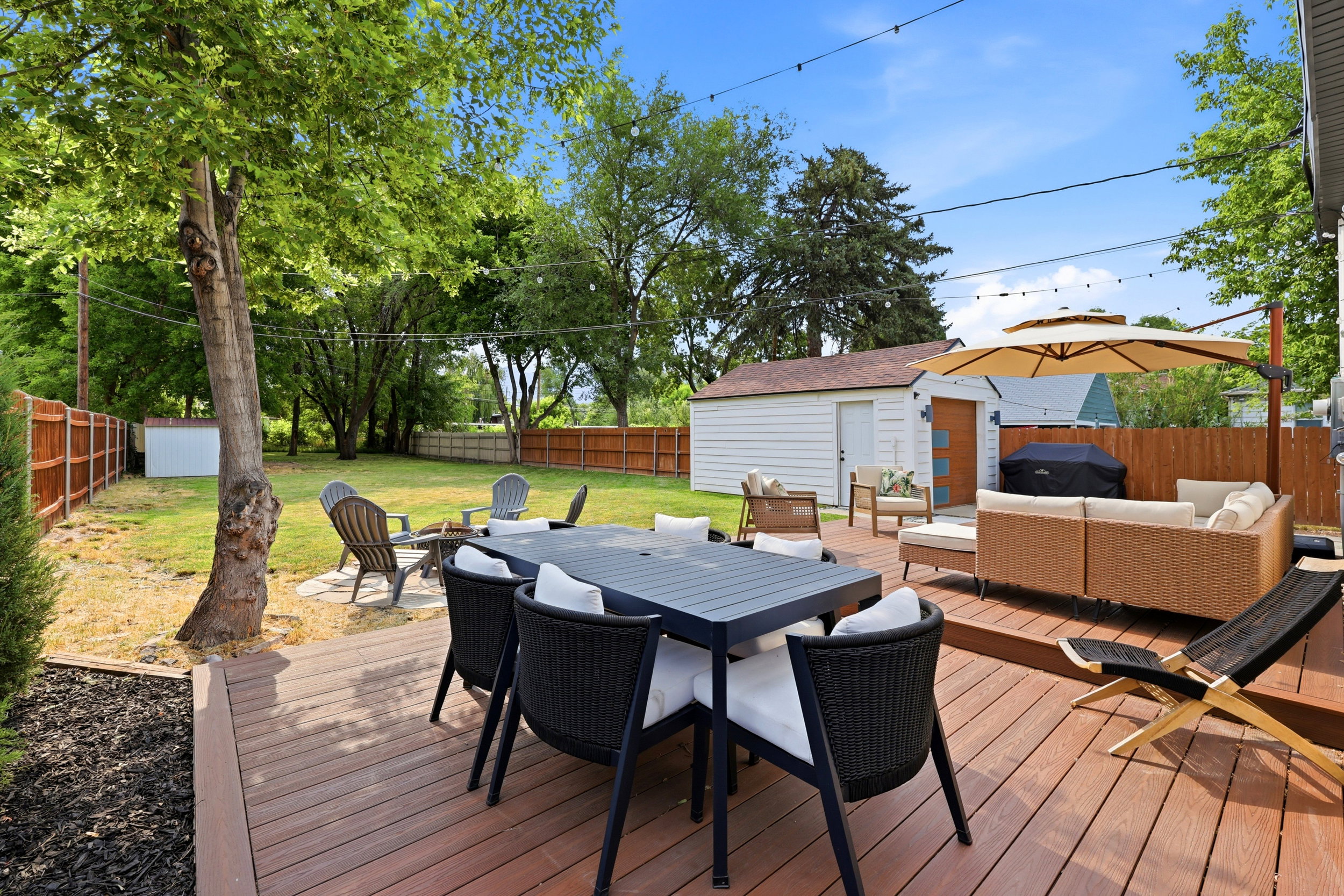 Expansive wood-finish deck with ample space for outdoor dining and lounge areas