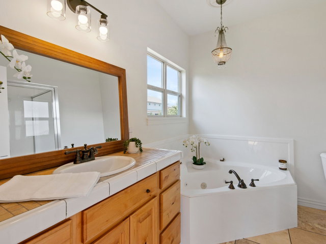 Primary bathroom features corner soaking tub and a separate glass shower enclosure