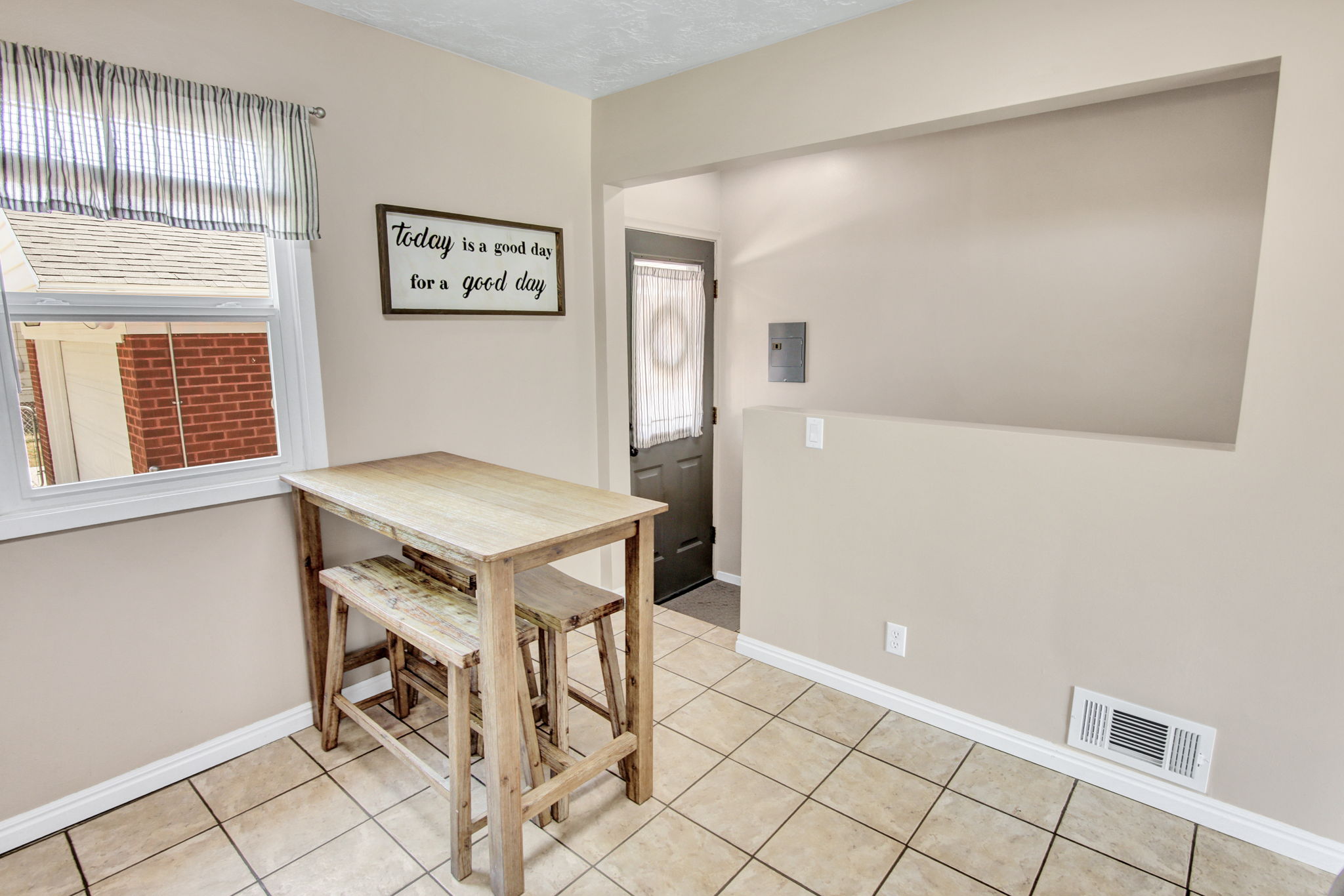 Tiled flooring and a window with natural light define this interior space