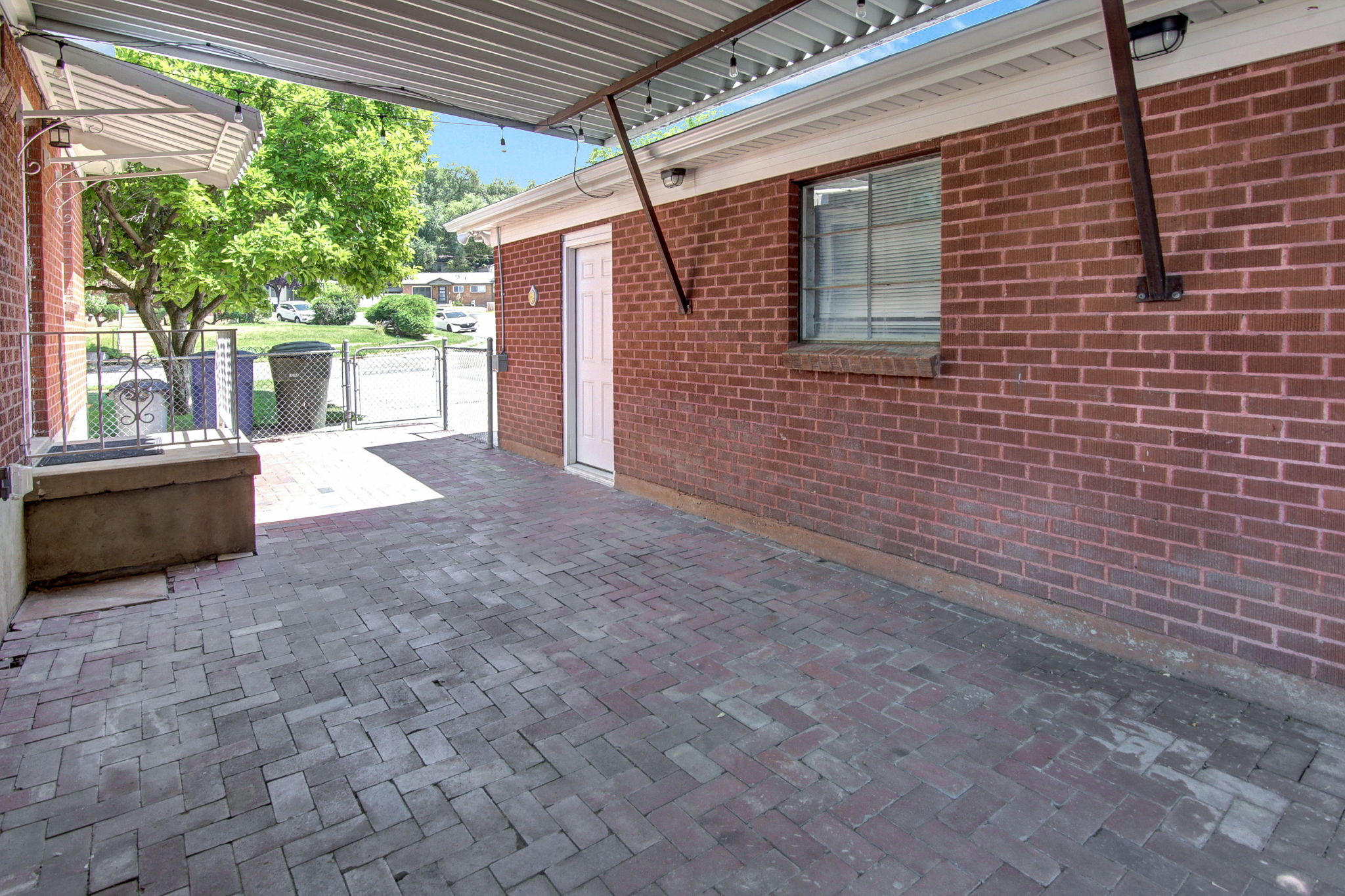 Covered outdoor patio with brick paver flooring