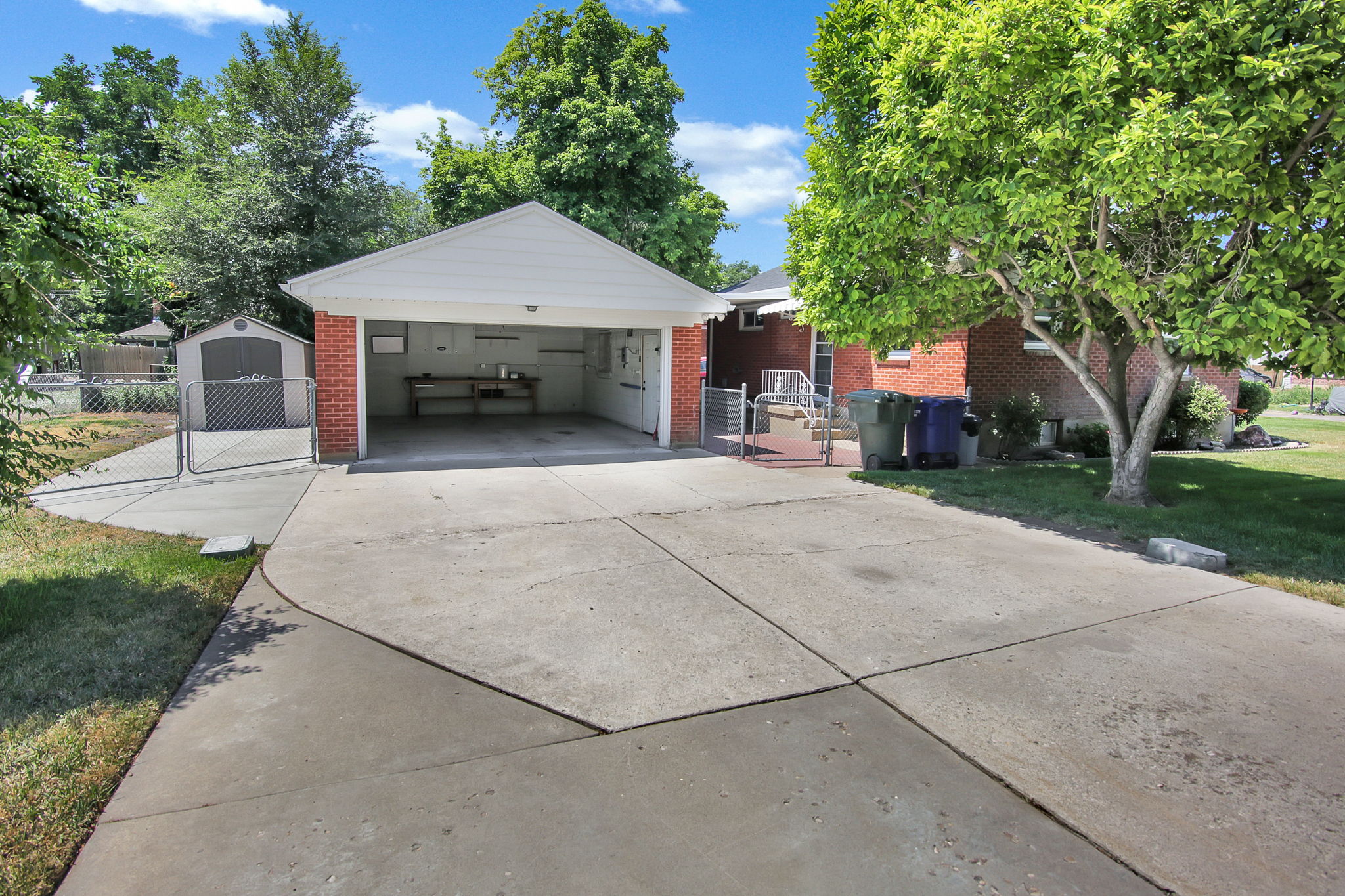 Detached brick garage with an extended concrete driveway