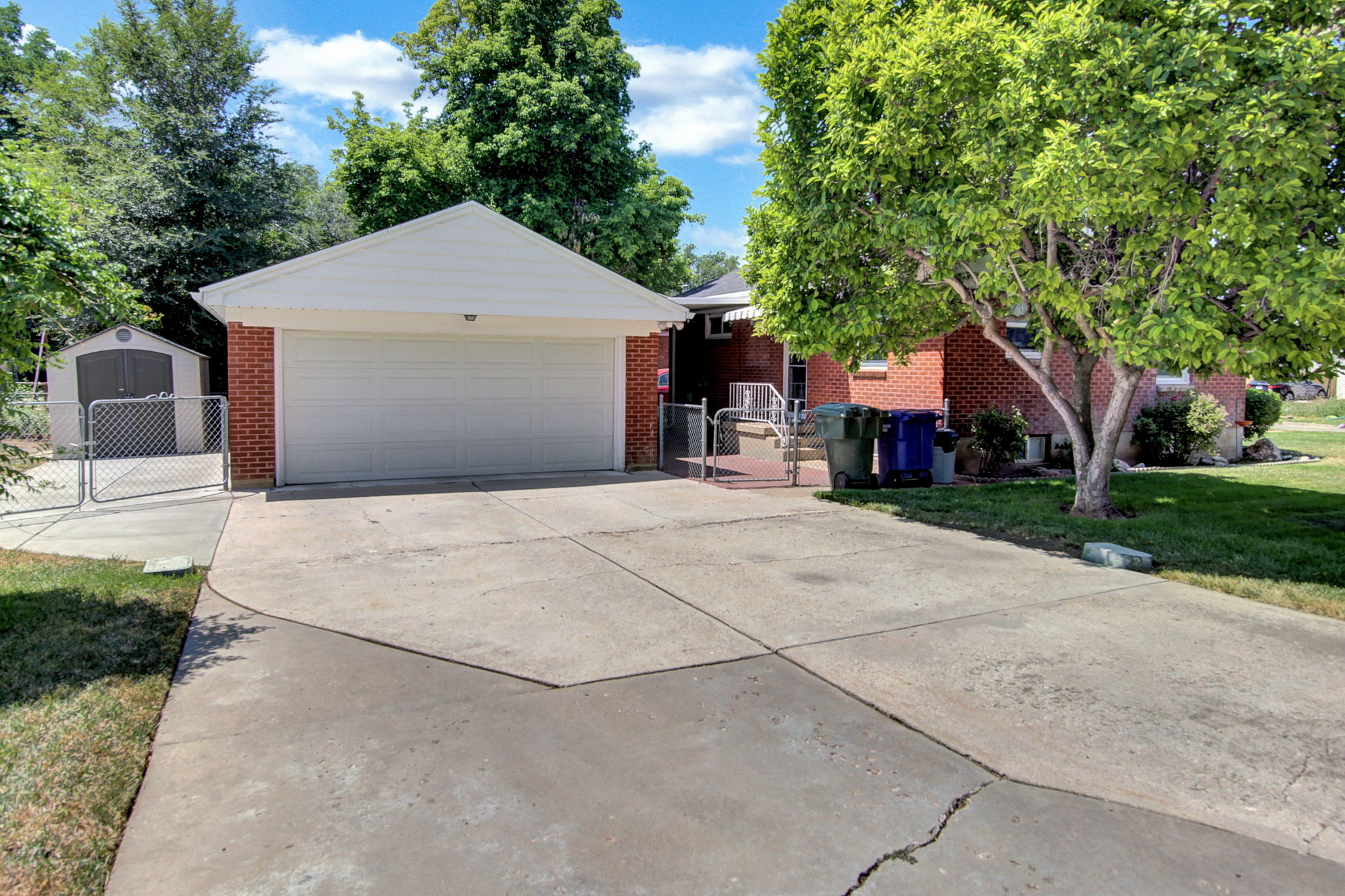 Attached two-car garage with white paneled door and brick exterior