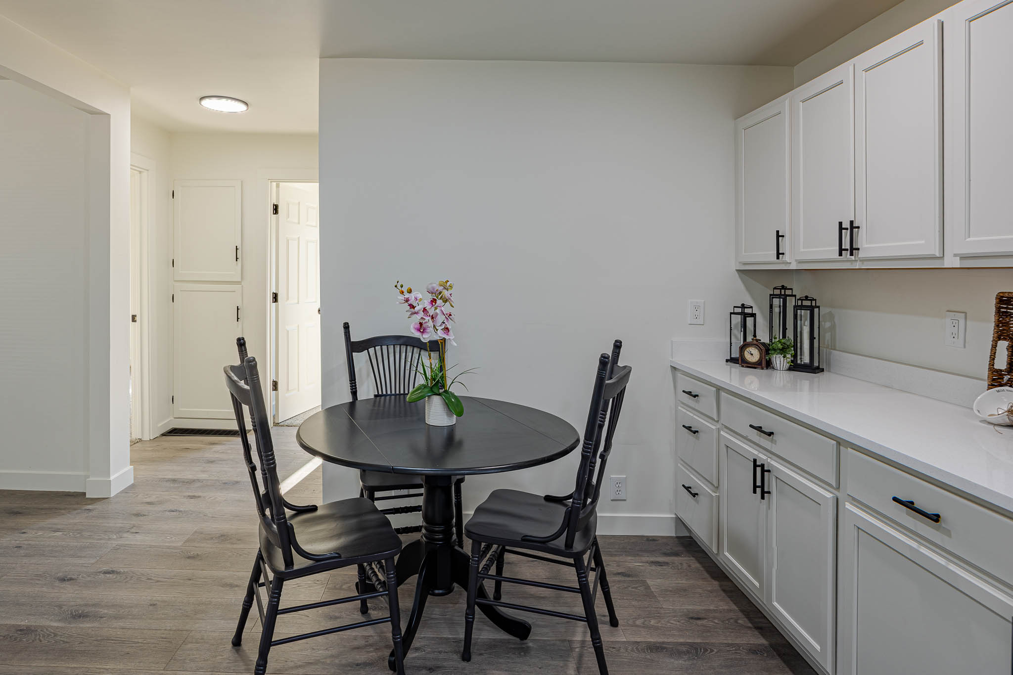 Wood-finish flooring throughout, complemented by white walls