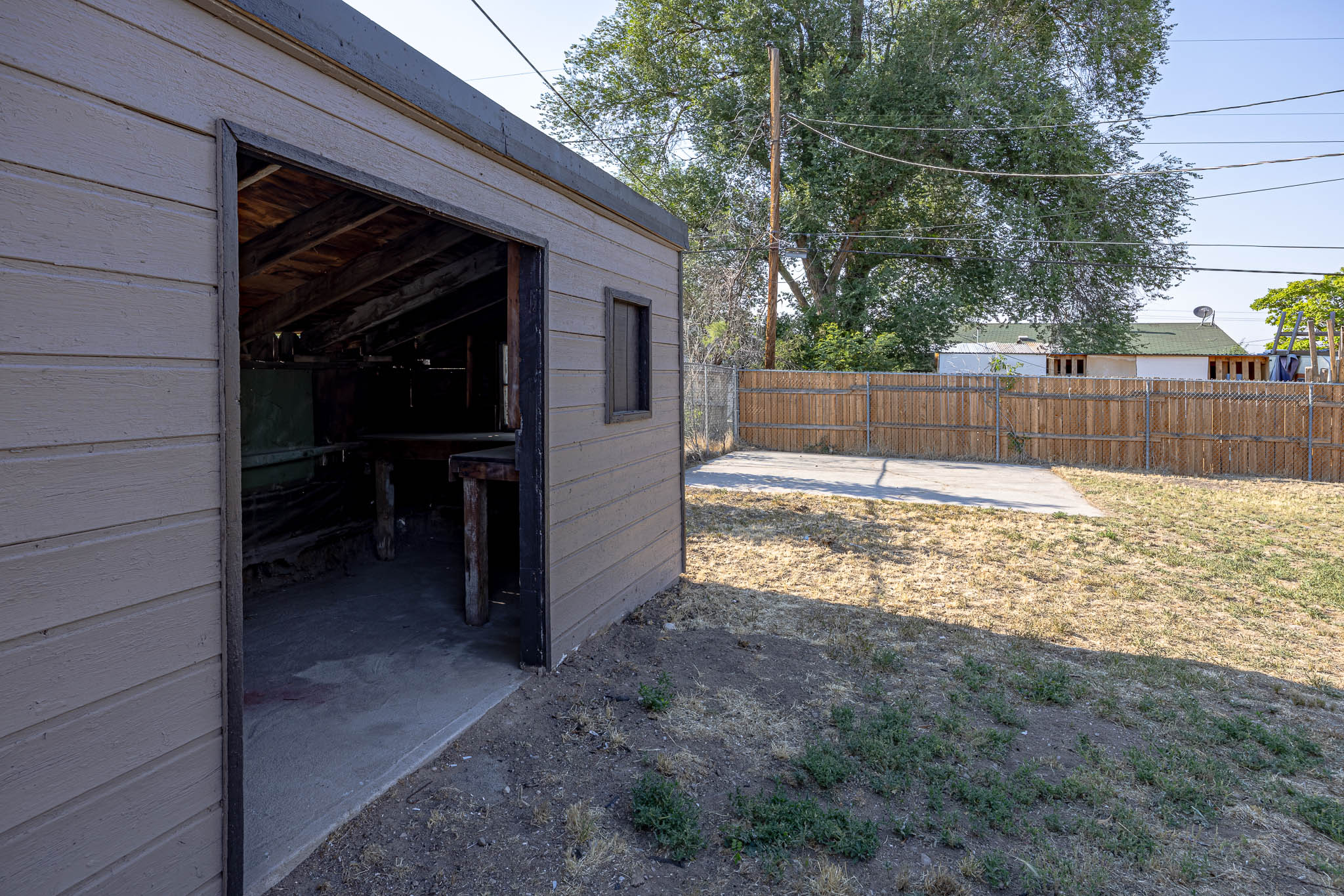 Detached outbuilding with shiplap siding and a concrete floor