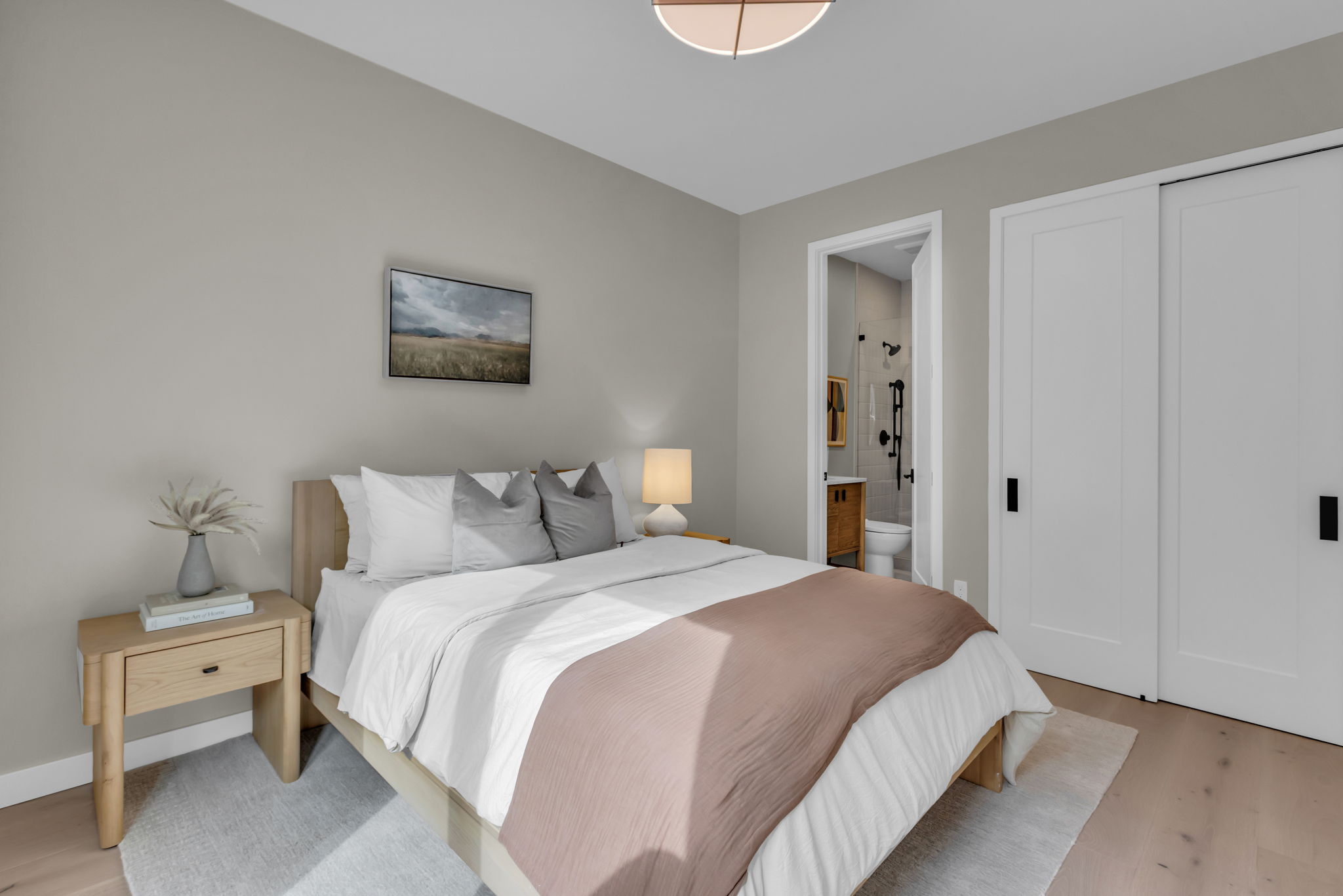 Light wood-finish flooring complements the neutral wall color