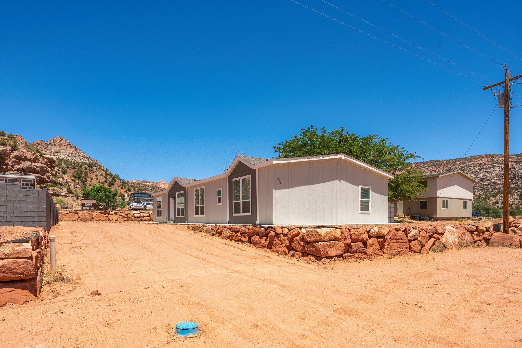 Newly constructed modular property featuring a light-toned exterior with dark trim accents and multiple window placements
