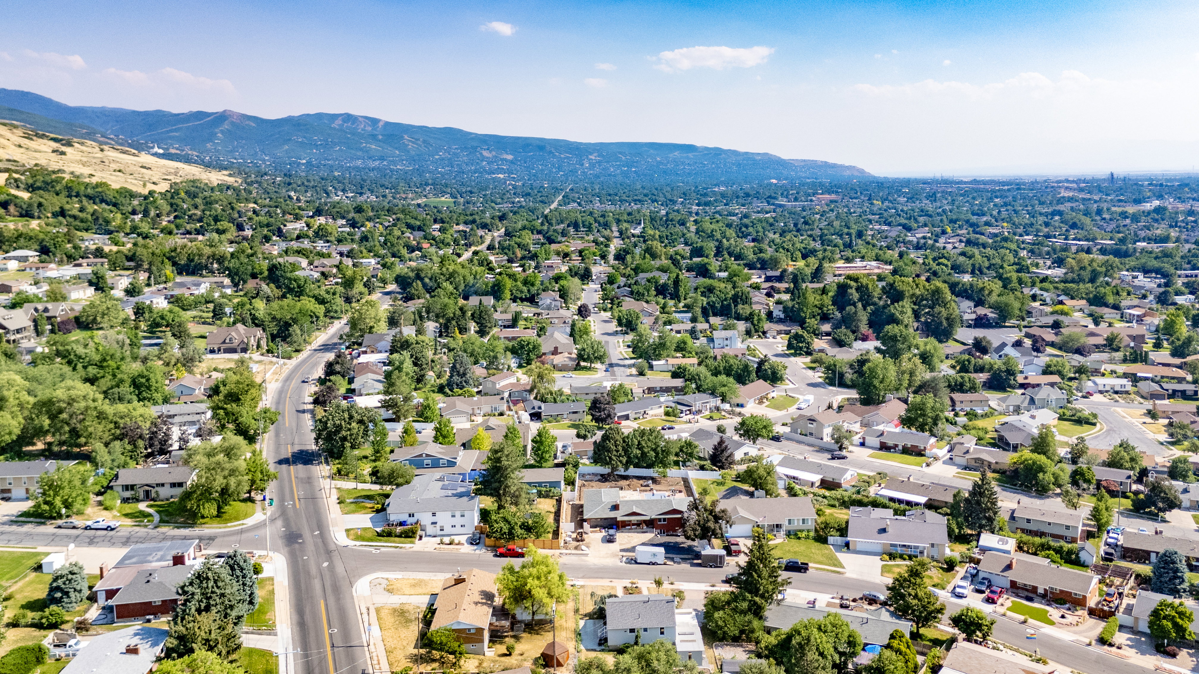 Expansive residential area with a verdant landscape and distant mountains