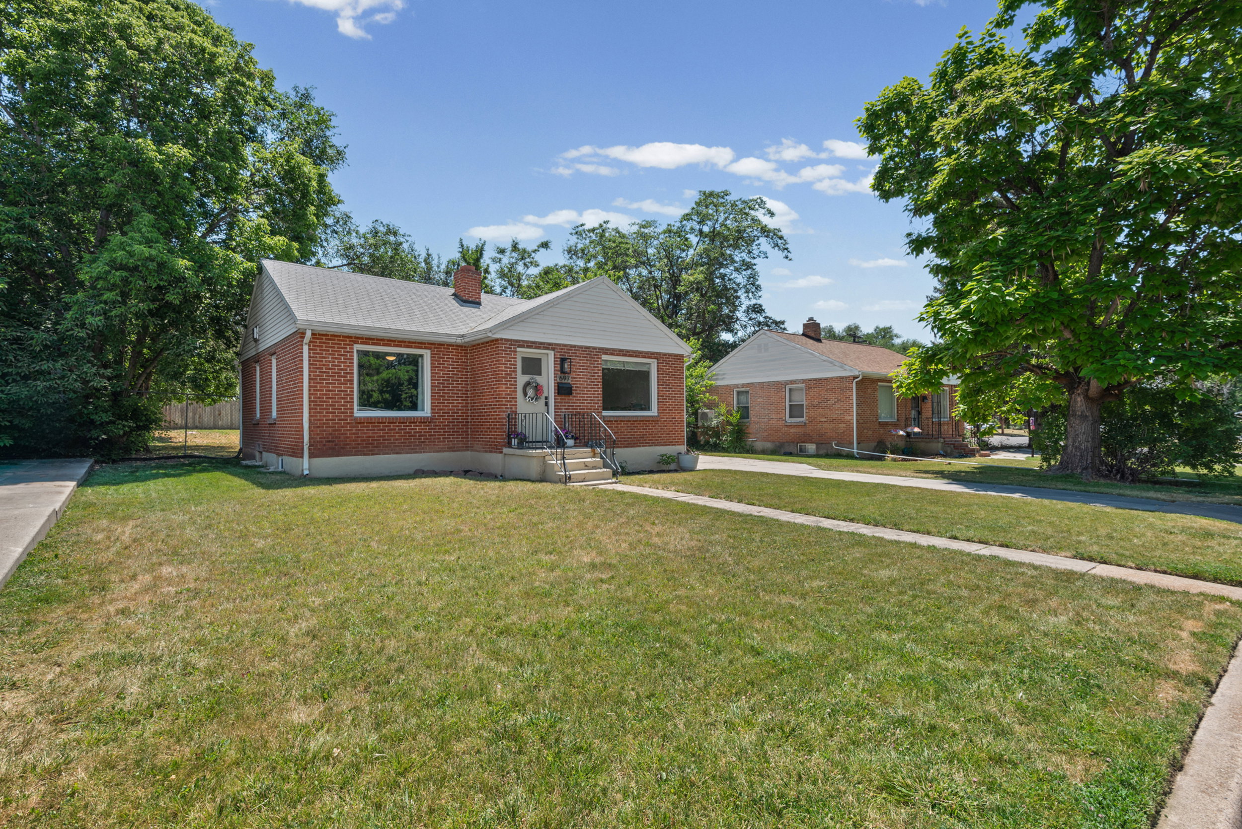 Brick exterior residence with a gabled roofline