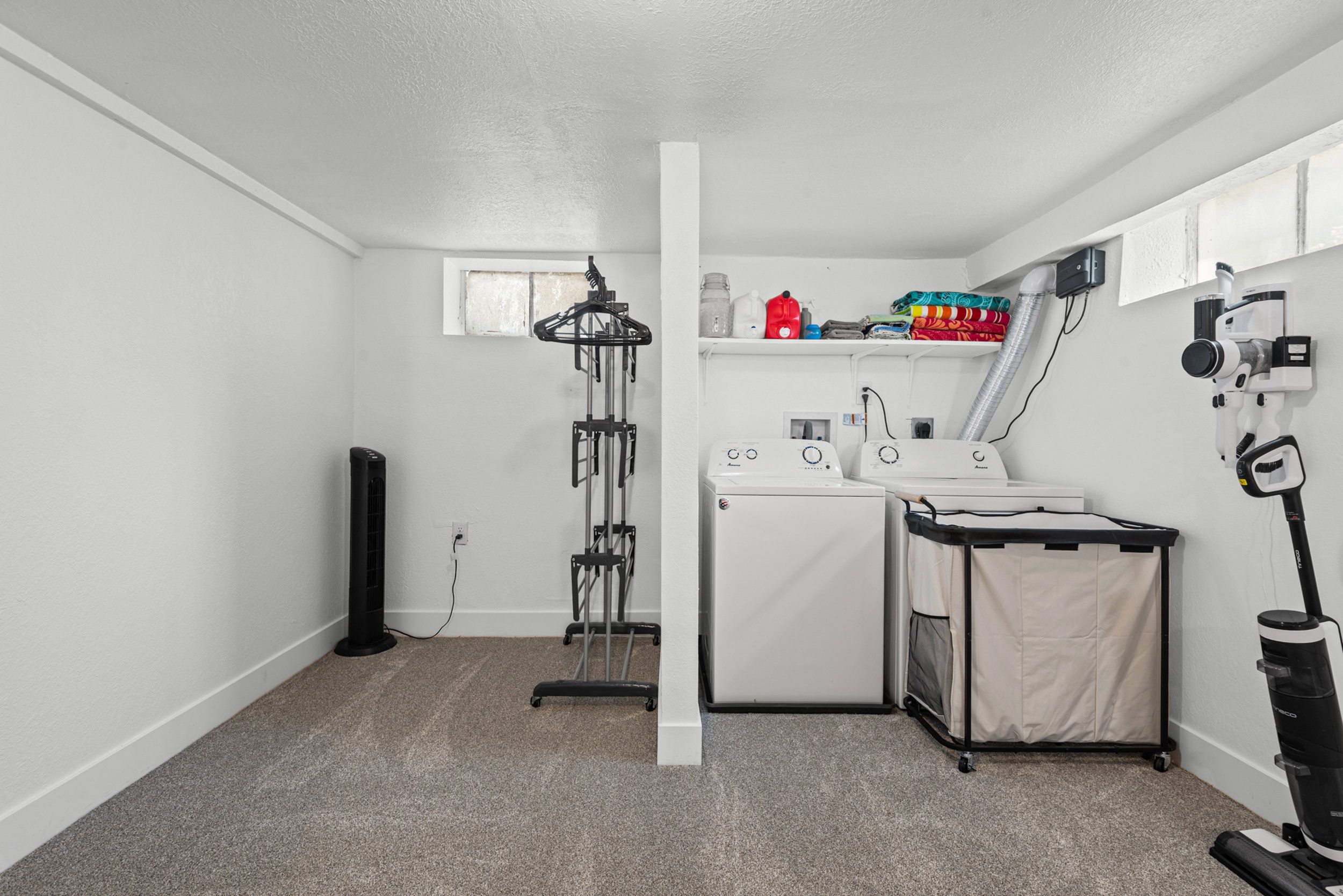 Dedicated laundry area with white walls and baseboards