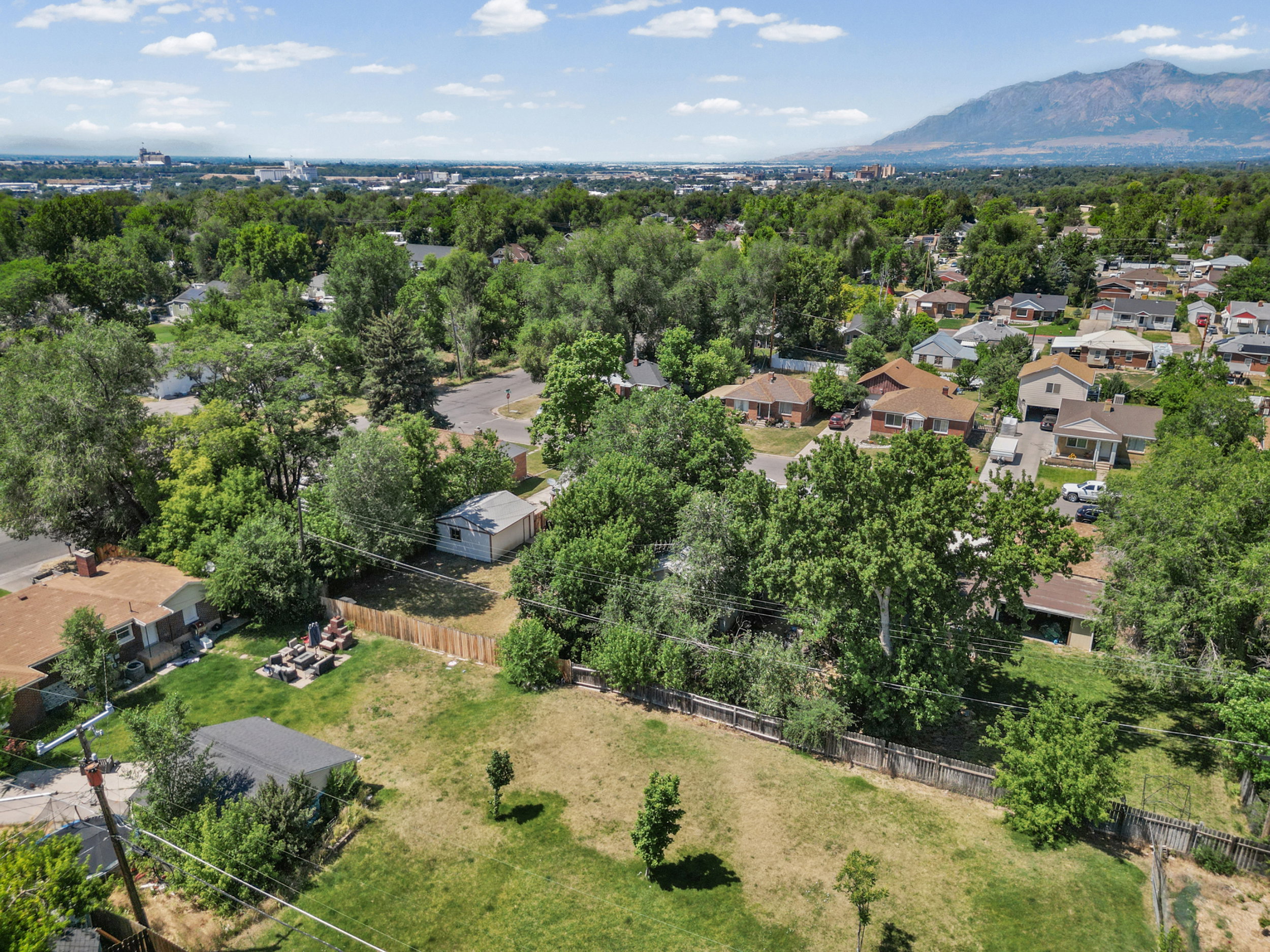 Expansive lot with mature trees and a fenced perimeter