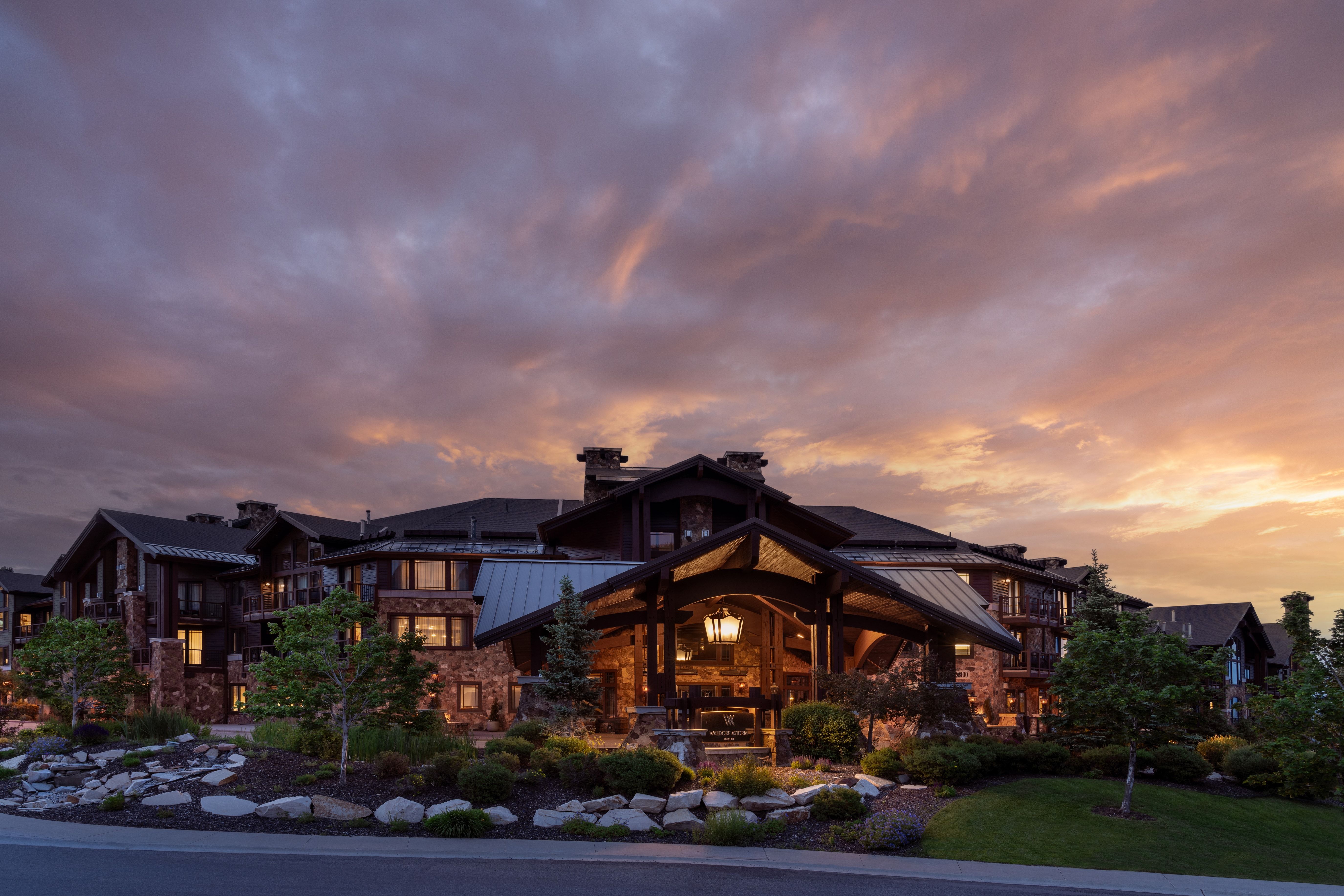 Expansive lodge-style building featuring a stone and wood exterior with multiple balconies