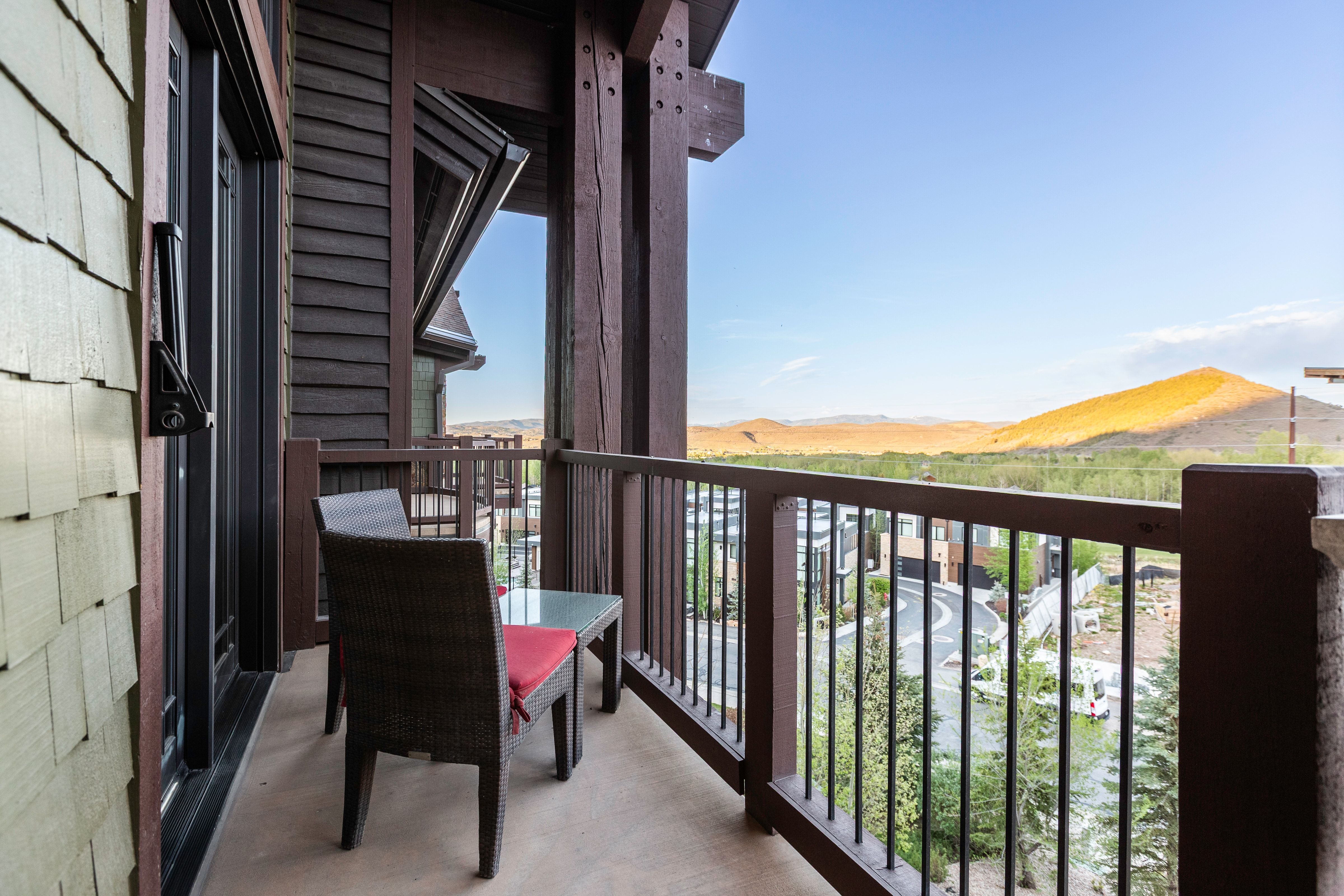 Private balcony featuring wood-shingle siding, robust timber framing, metal railing, and a durable concrete surface