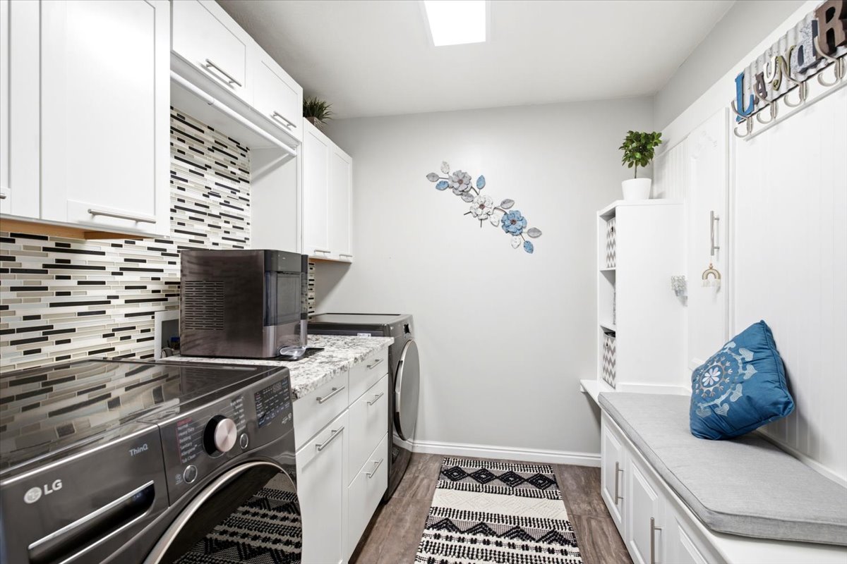 Large laundry with lots of storage and custom backsplash