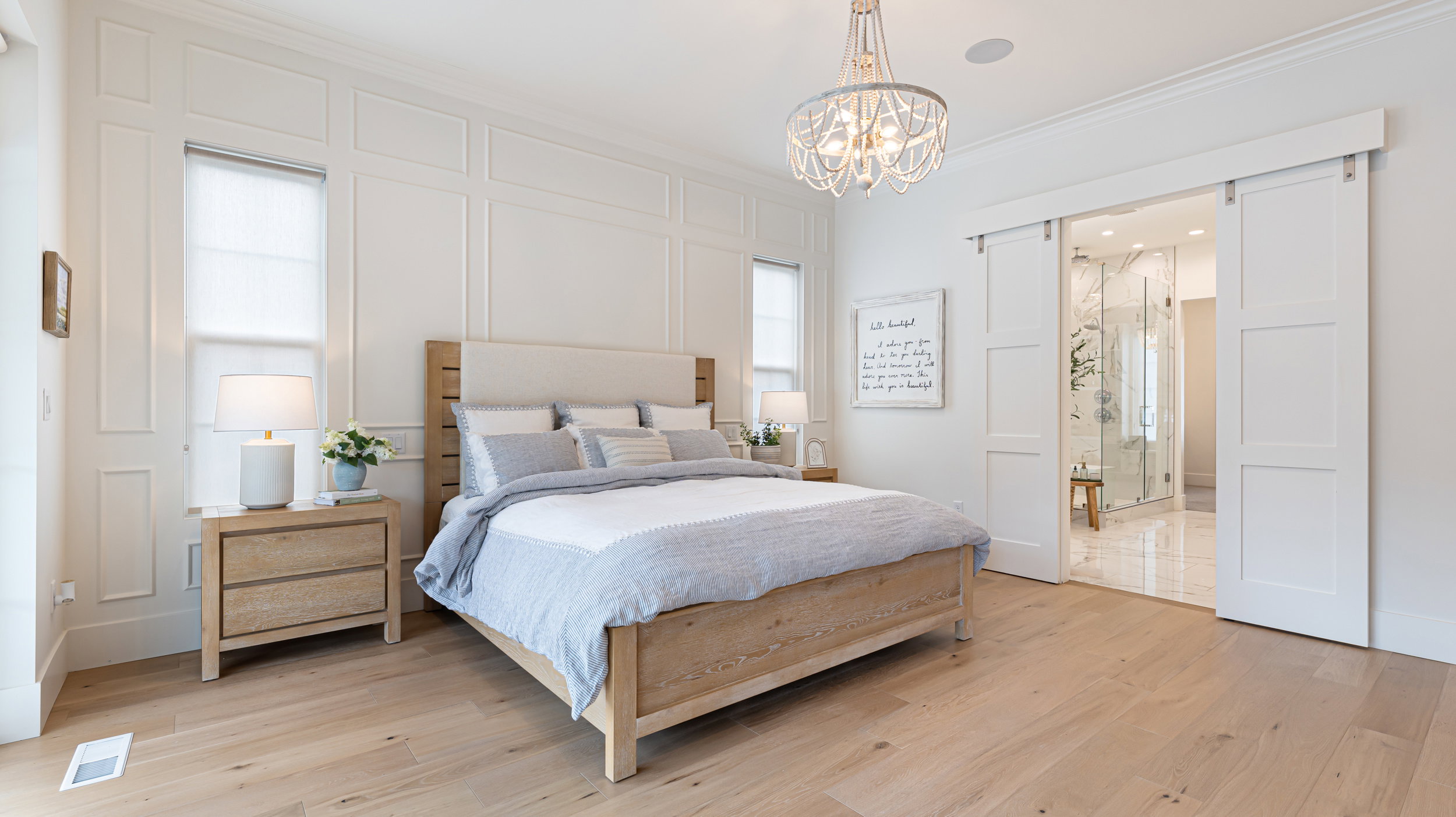 Light wood-finish flooring complements the detailed wall paneling