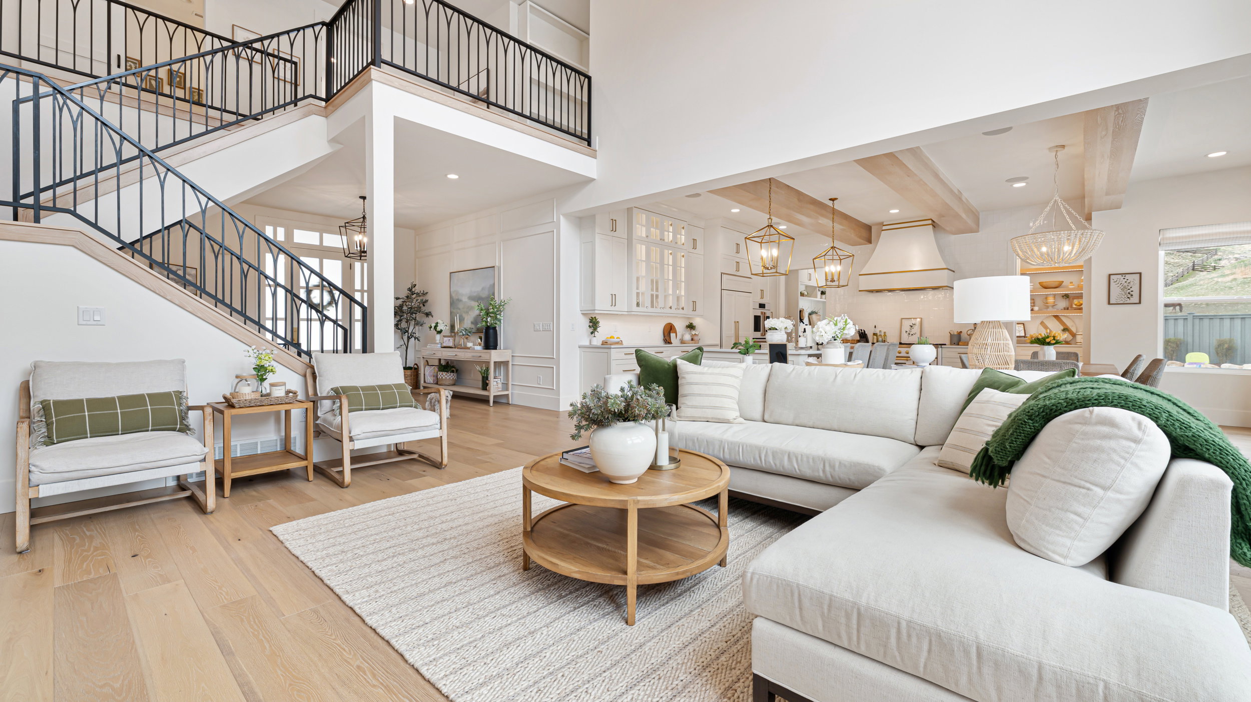 Vaulted ceilings with exposed wood beams define this open-concept living area