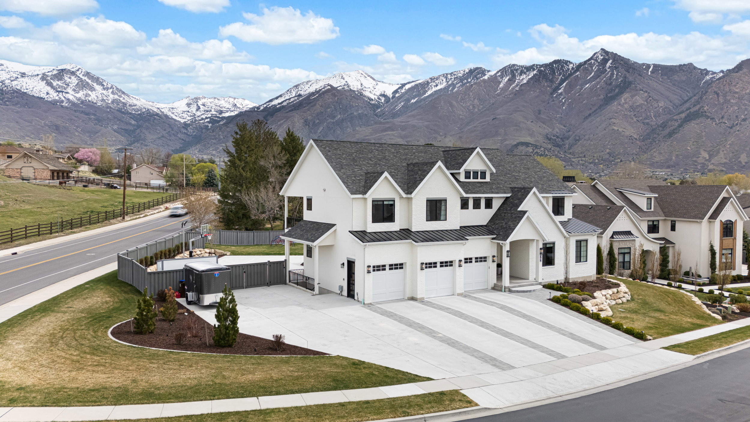 Contemporary white exterior with a multi-gabled roofline and dark trim accents