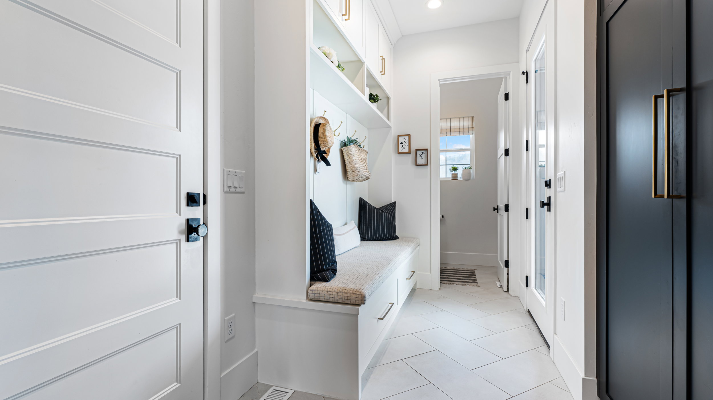 Built-in mudroom bench with upper cabinetry and integrated storage drawers