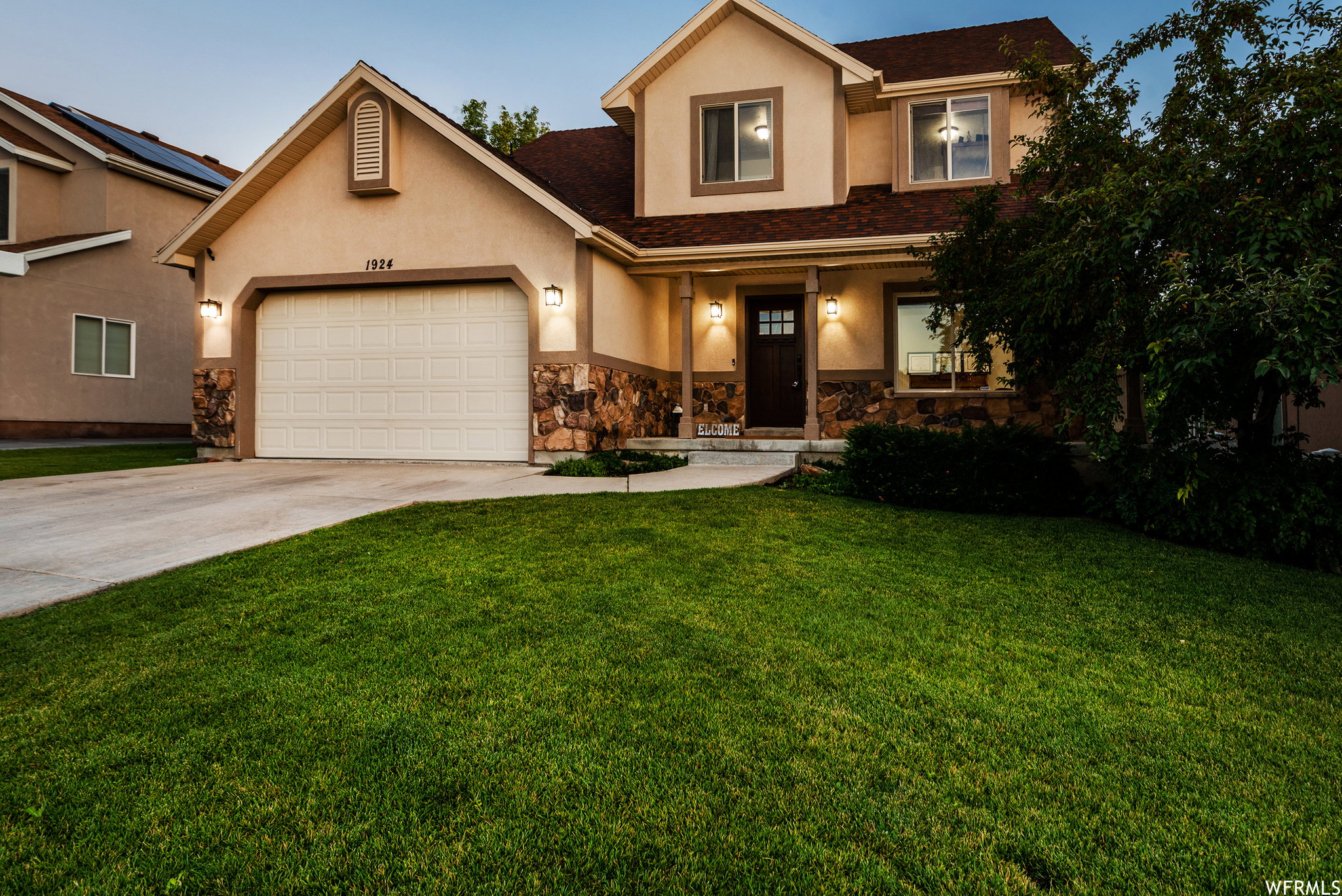 Front exterior with stucco and stone veneer accents
