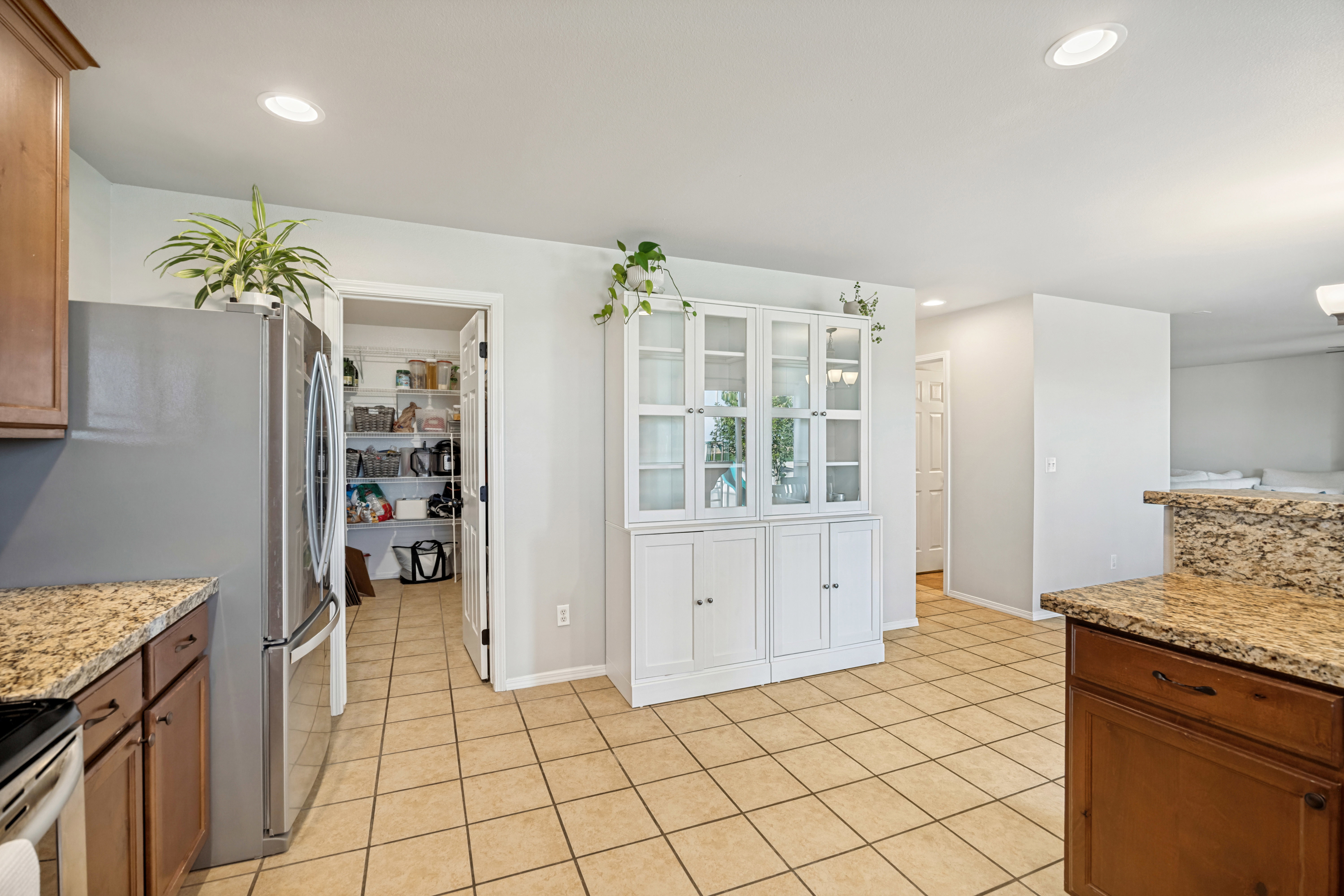 Kitchen featuring tile flooring, recessed lighting, and a built-in pantry with wire shelving